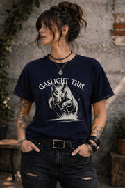 Woman wearing navy blue graphic t-shirt with gaslight this rhino design outdoors rustic background