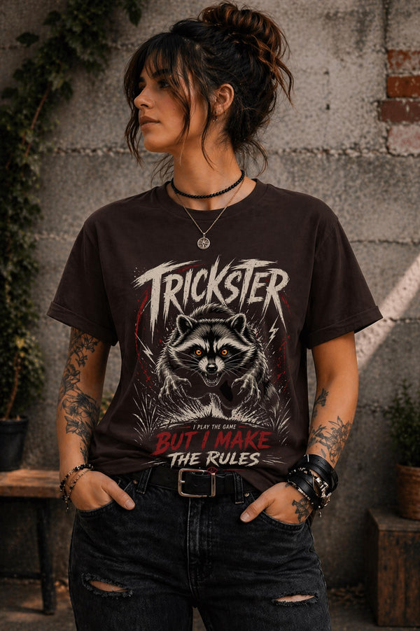 Woman wearing dark brown raccoon graphic t-shirt with trickster slogan outdoors