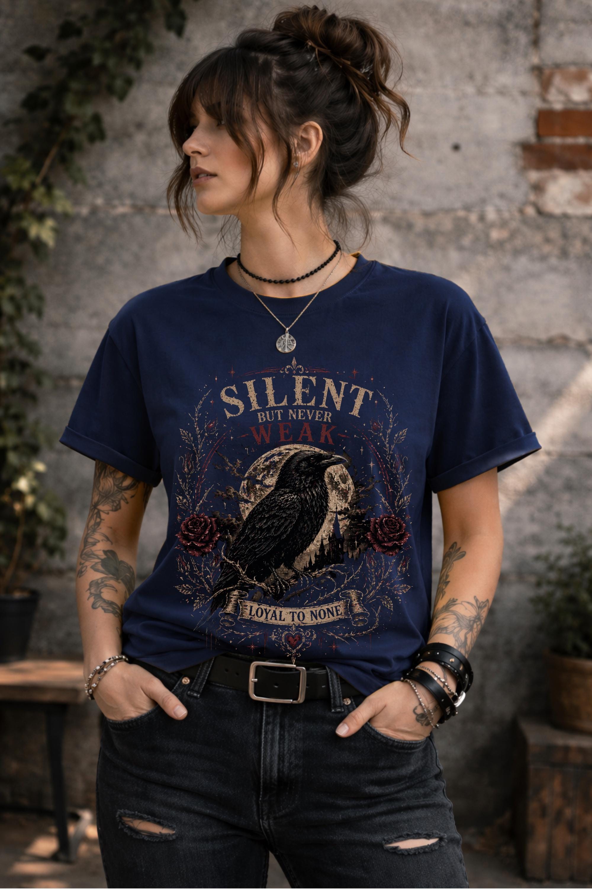 Woman wearing gothic raven shirt in moody outdoor setting, dark academia fashion with edgy alternative style