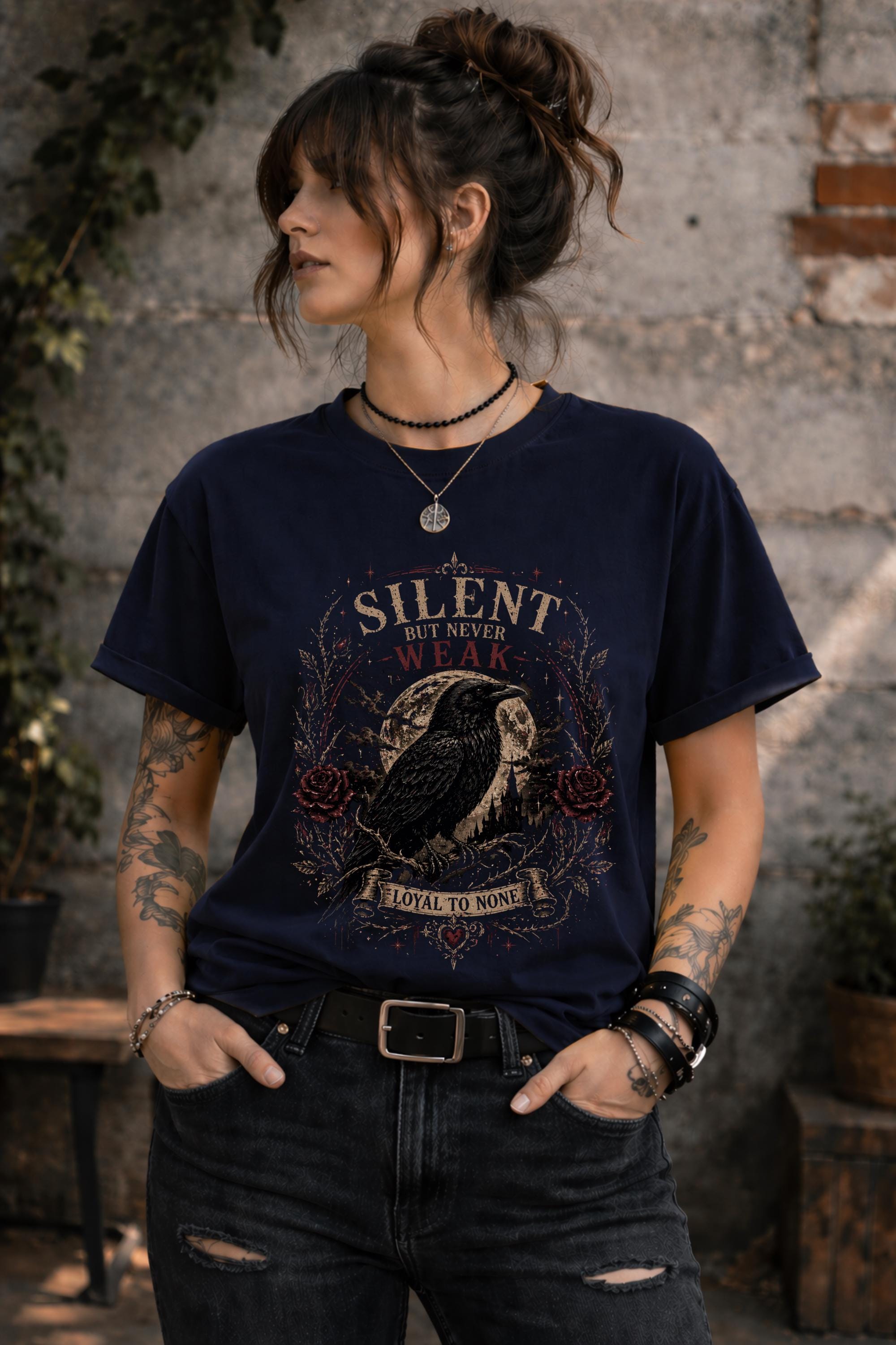 Woman wearing gothic raven shirt in moody outdoor setting, dark academia fashion with edgy alternative style