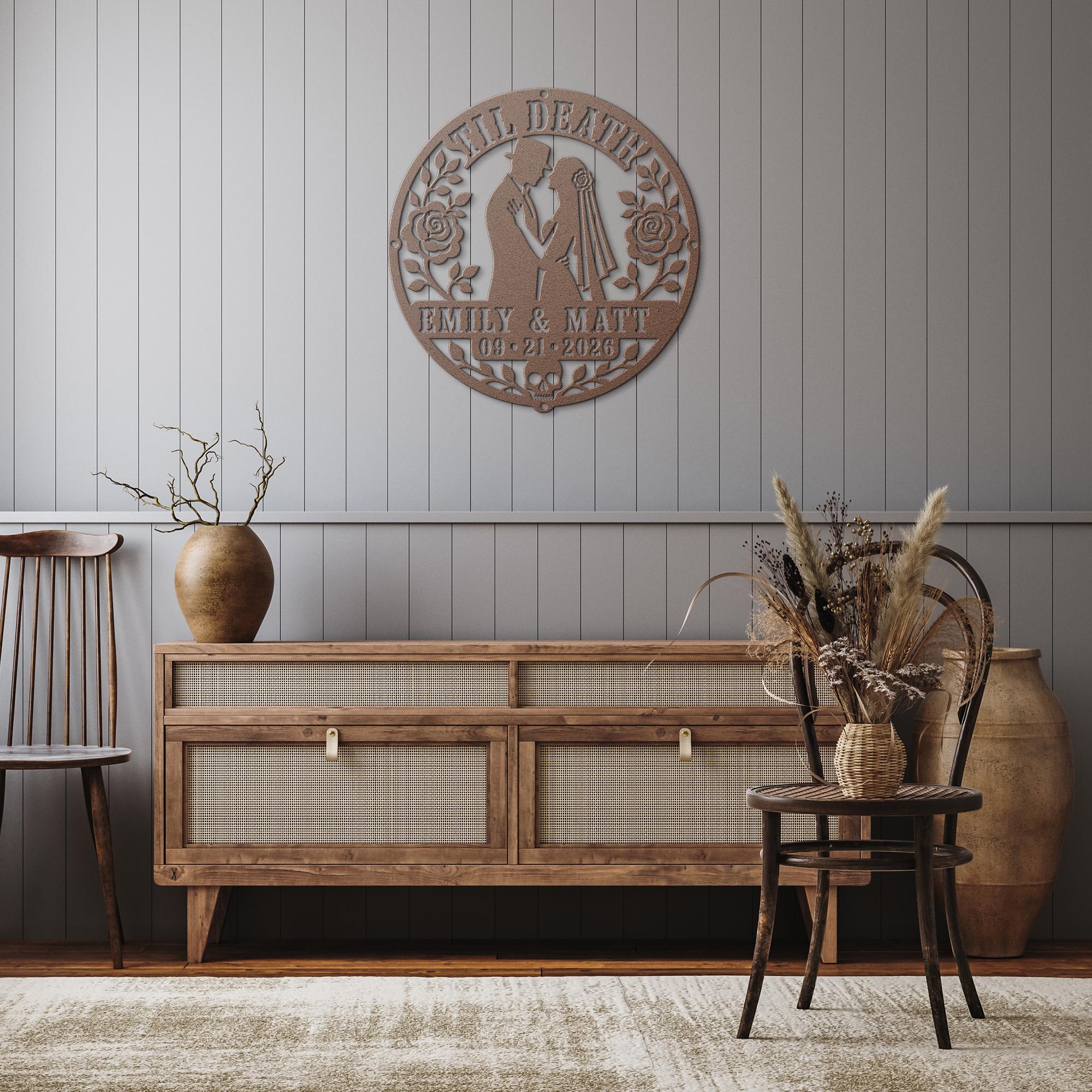 Gothic metal wall decor with til death couple design and custom names displayed above a rustic console with candles and skull accents