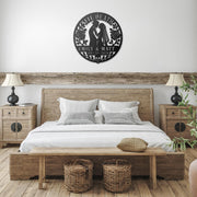 Gothic metal wall decor with til death couple design and custom names displayed above a rustic console with candles and skull accents