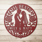 Gothic metal wall decor with til death couple design and custom names displayed above a rustic console with candles and skull accents