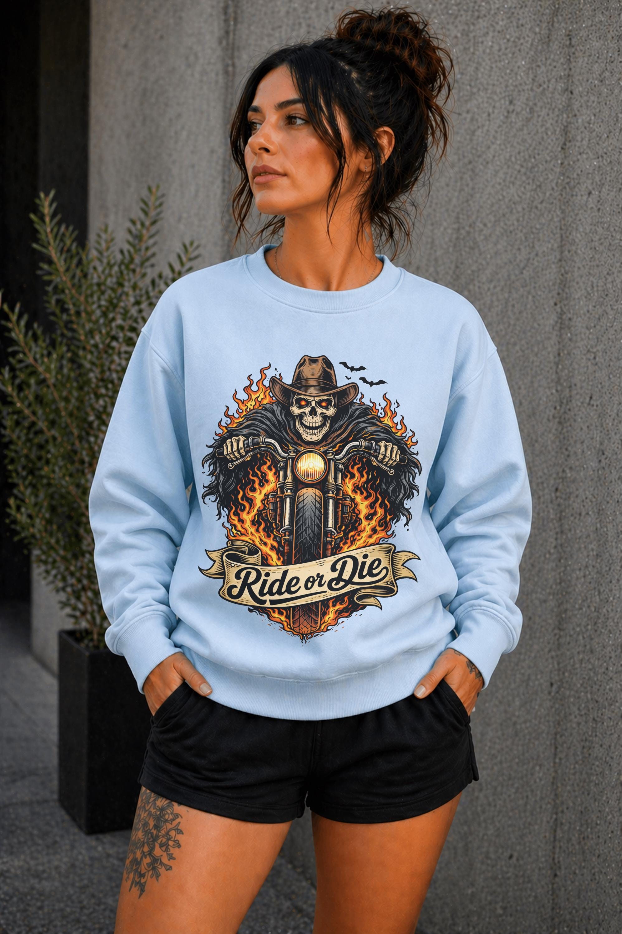 Woman wearing navy biker graphic shirt with skull motorcycle ride or die design