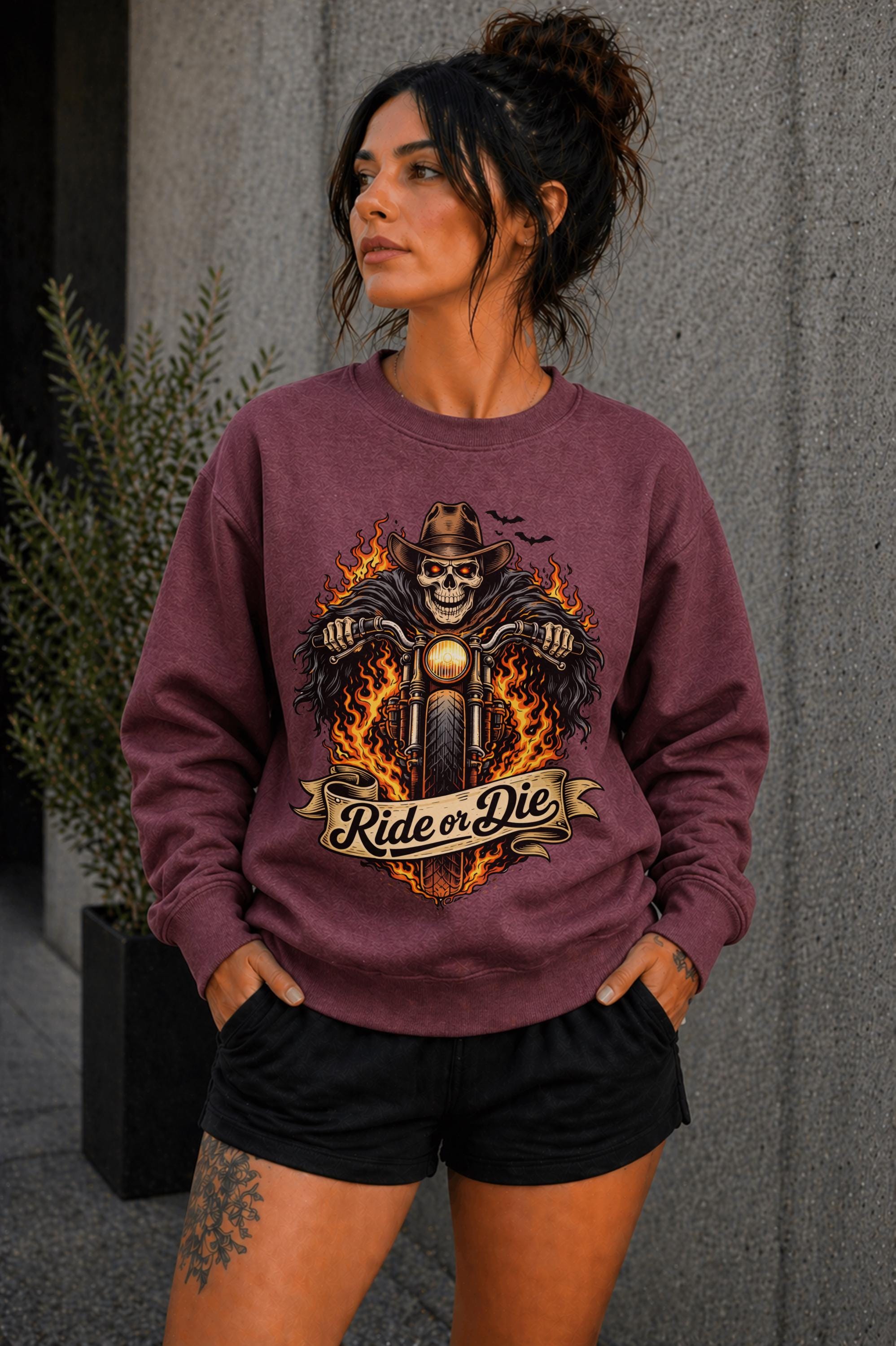 Woman wearing navy biker graphic shirt with skull motorcycle ride or die design