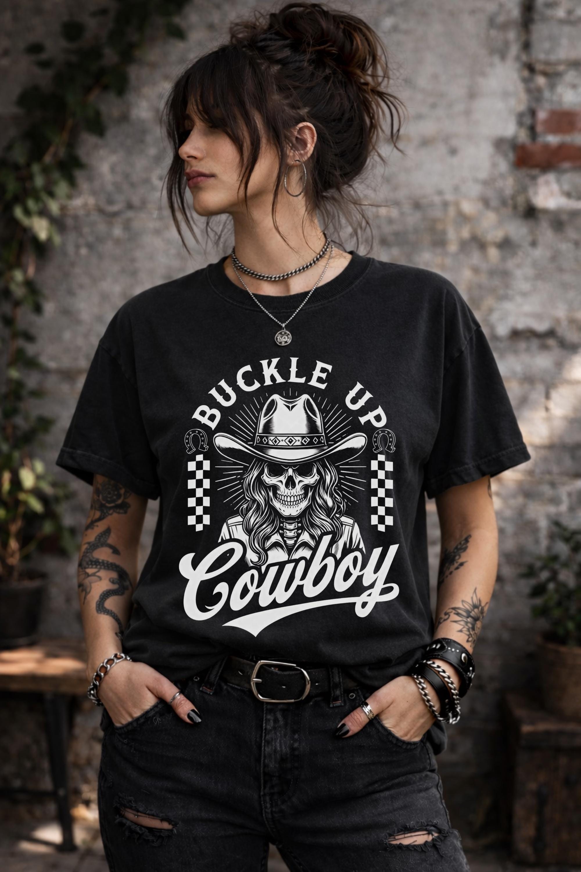 Woman wearing black western graphic shirt with skull cowboy buckle up cowboy design