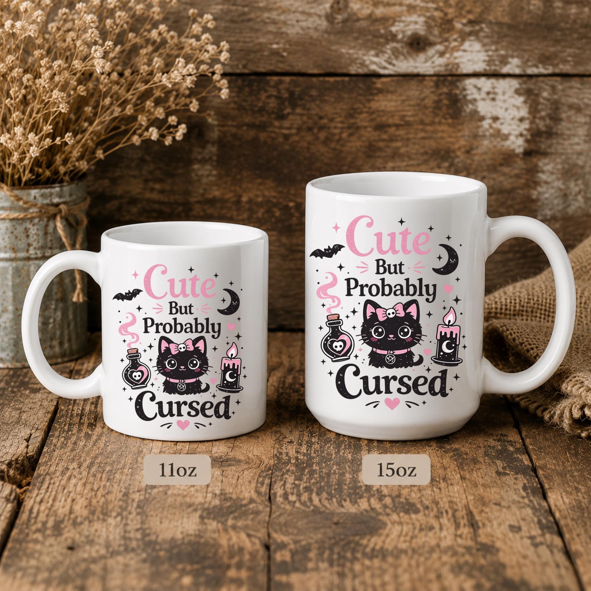 White ceramic mug featuring Cute But Probably Cursed gothic cat design in pink and black on rustic background