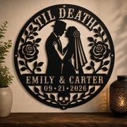 Gothic metal wall decor with til death couple design and custom names displayed above a rustic console with candles and skull accents