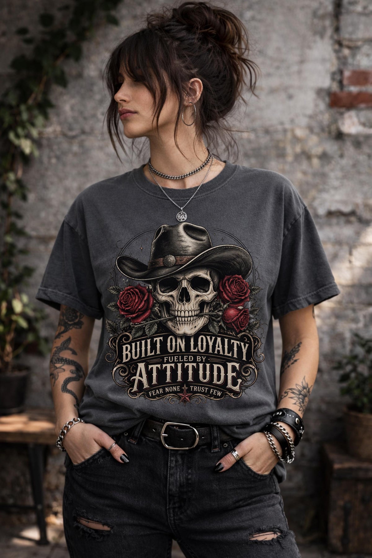 T-Shirt featuring cowboy skull with hat and red roses, Built on Loyalty Fueled by Attitude graphic, styled with edgy casual outfit