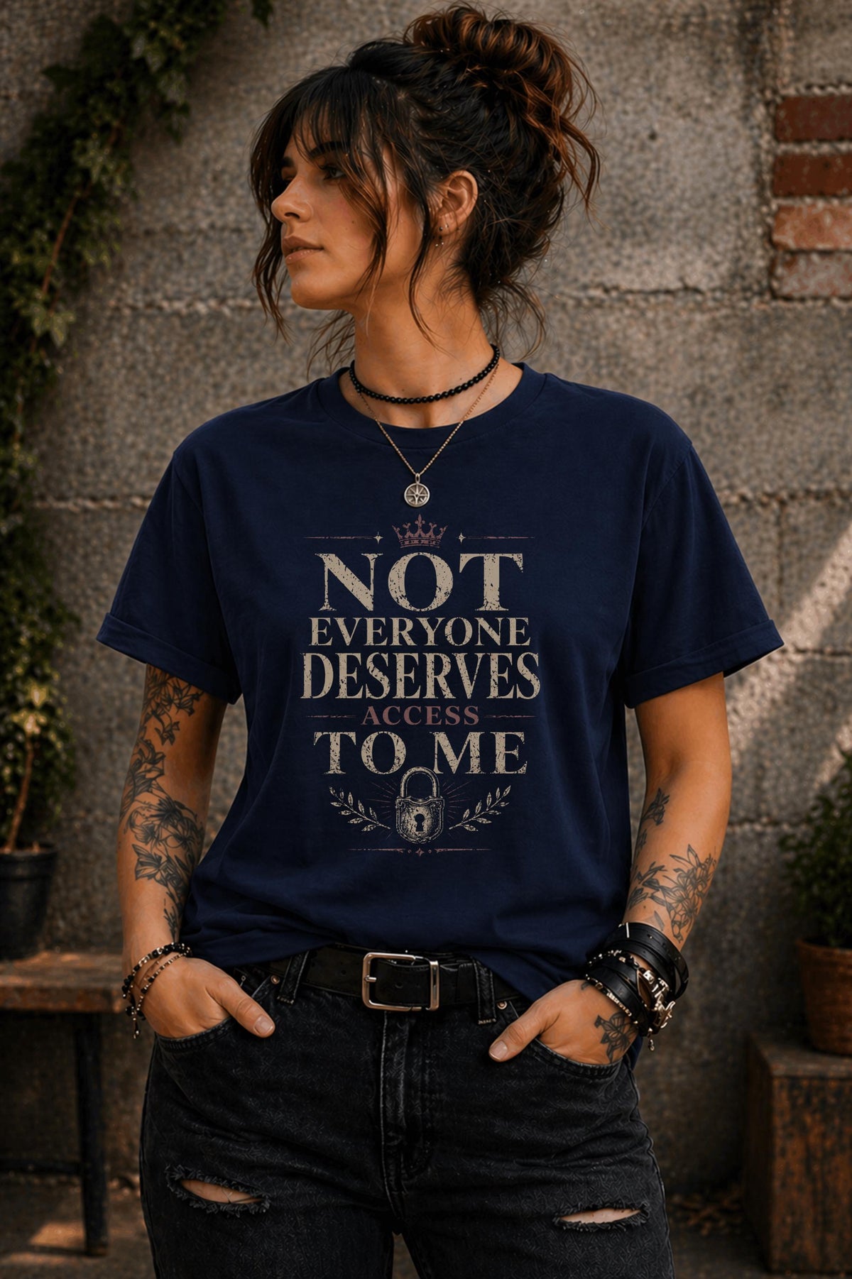 Woman wearing black graphic t-shirt with the phrase Not Everyone Deserves Access To Me in distressed vintage typography