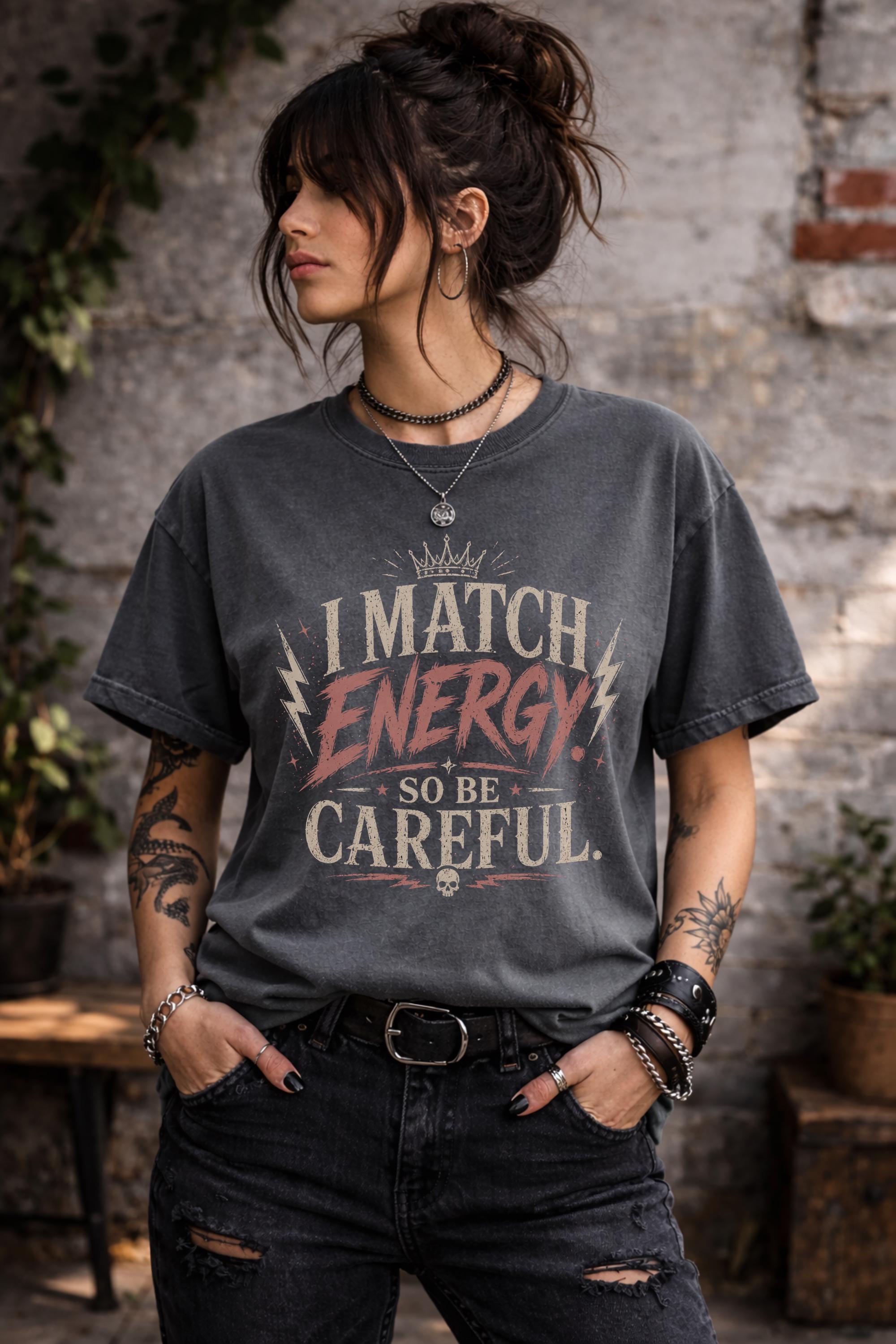 Woman wearing dark vintage wash graphic t-shirt featuring the phrase I Match Energy So Be Careful in distressed typography