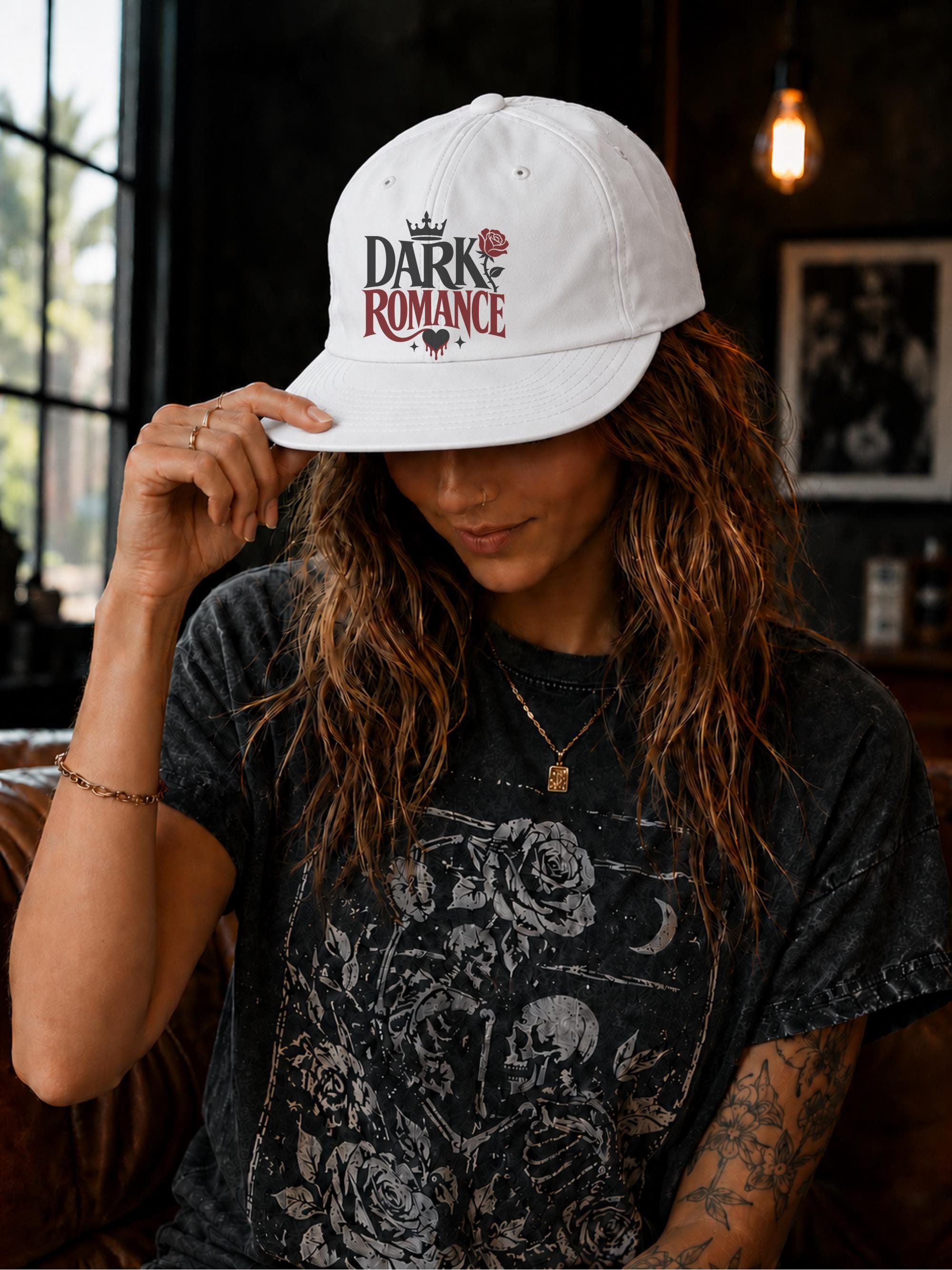 Woman wearing a surf cap featuring a Dark Romance graphic with red rose detail, photographed in a moody bookish setting with dark academia aesthetic.