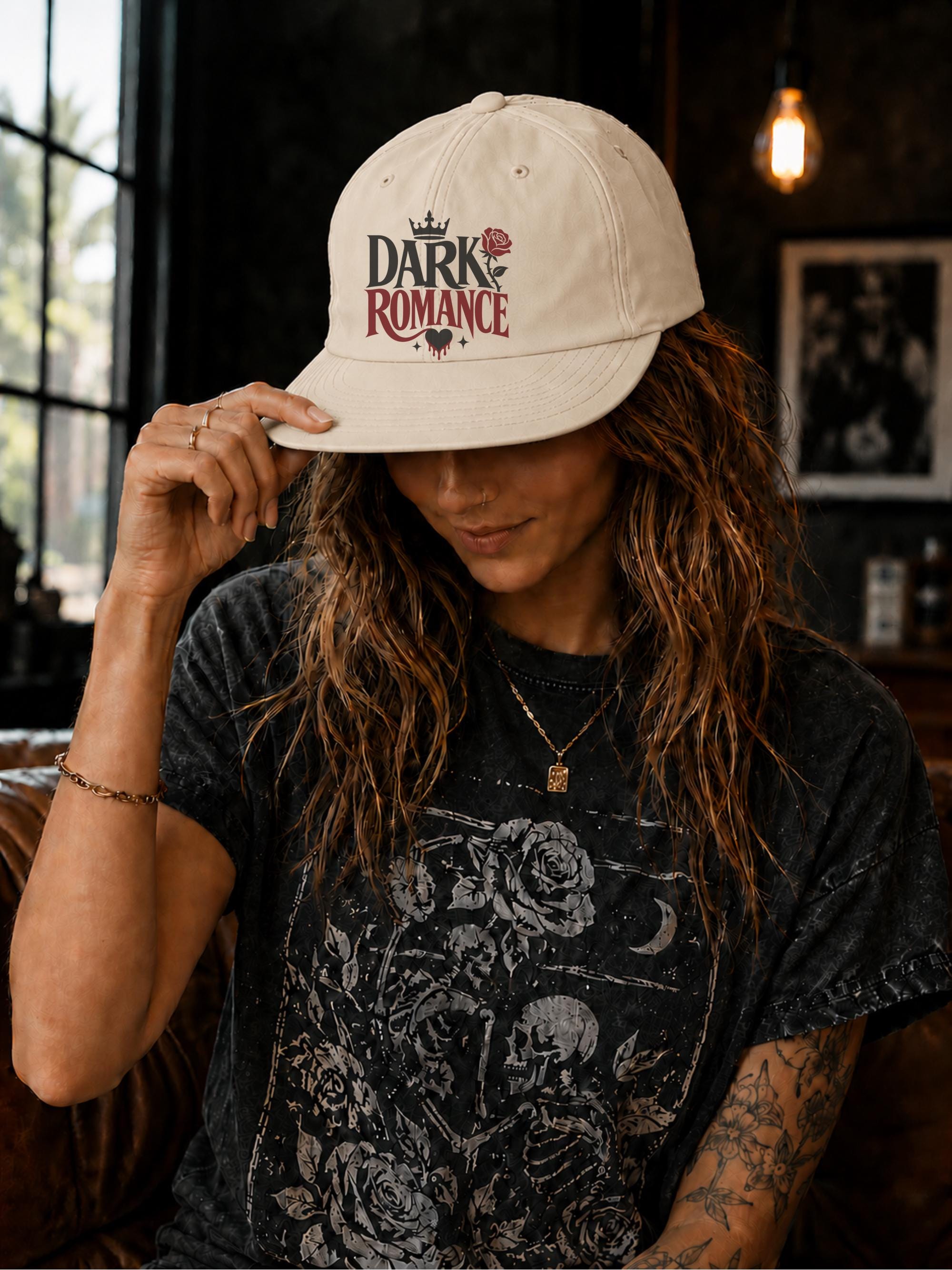 Woman wearing a surf cap featuring a Dark Romance graphic with red rose detail, photographed in a moody bookish setting with dark academia aesthetic.