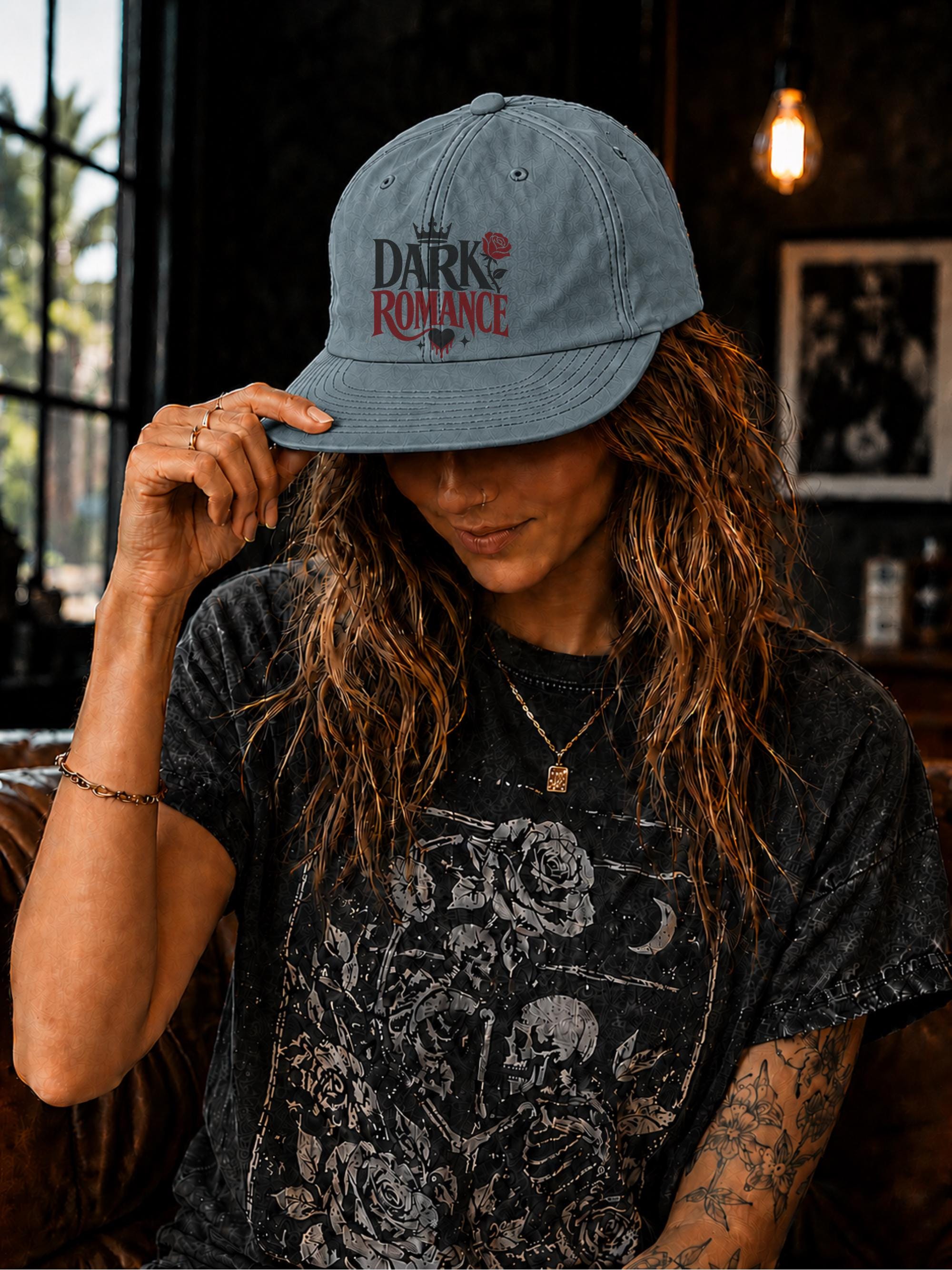 Woman wearing a surf cap featuring a Dark Romance graphic with red rose detail, photographed in a moody bookish setting with dark academia aesthetic.