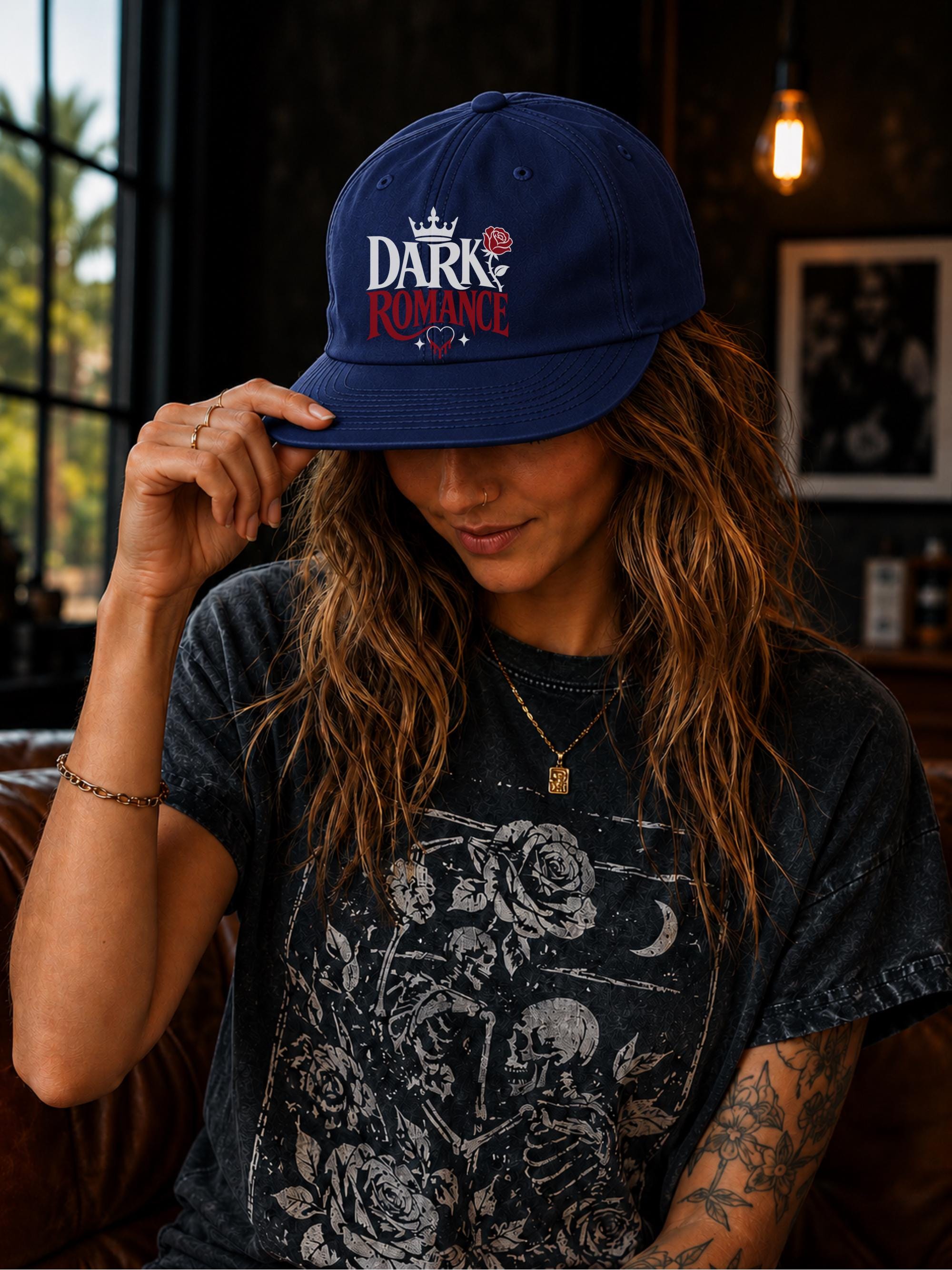 Woman wearing a surf cap featuring a Dark Romance graphic with red rose detail, photographed in a moody bookish setting with dark academia aesthetic.
