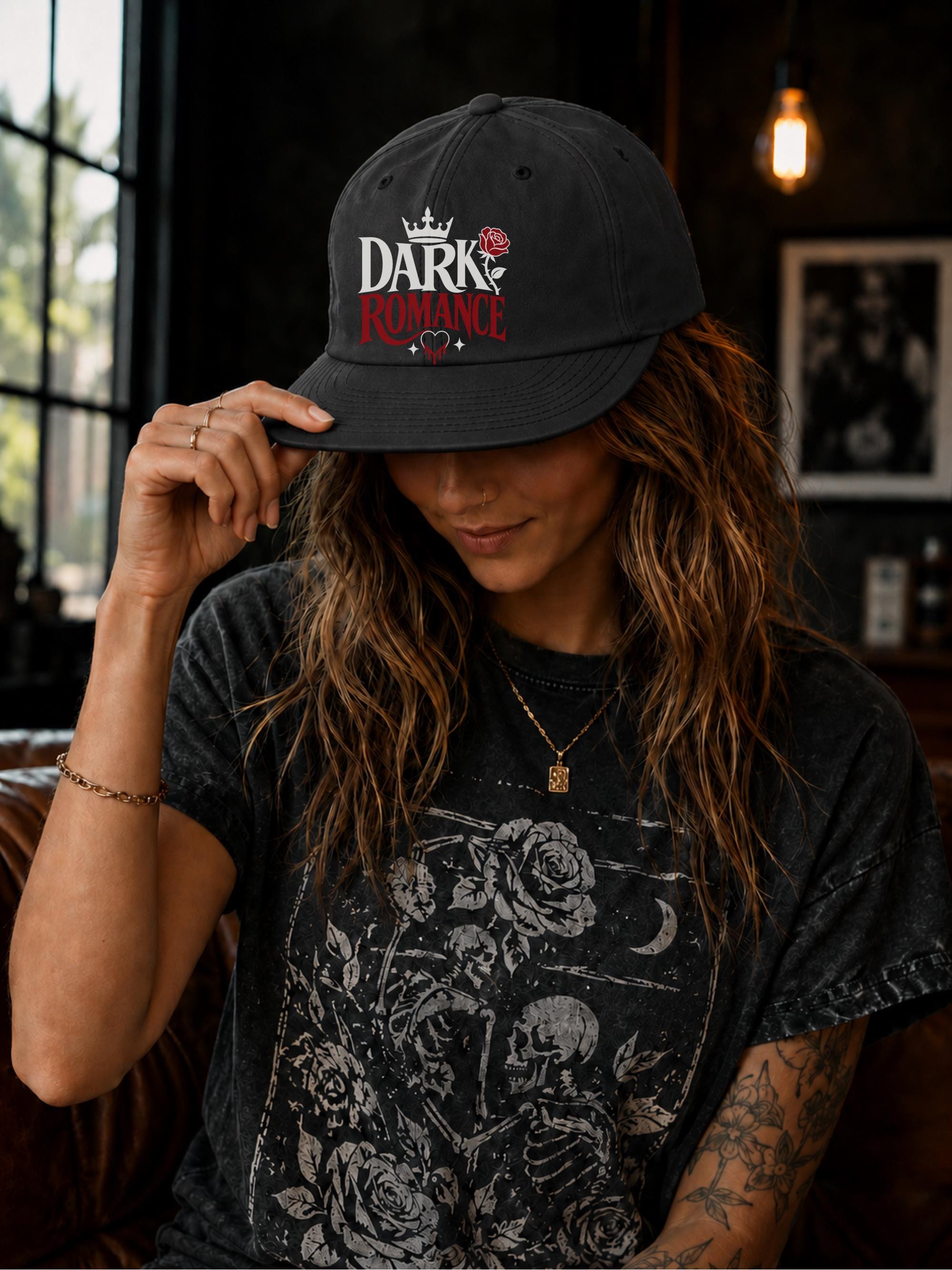 Woman wearing a surf cap featuring a Dark Romance graphic with red rose detail, photographed in a moody bookish setting with dark academia aesthetic.