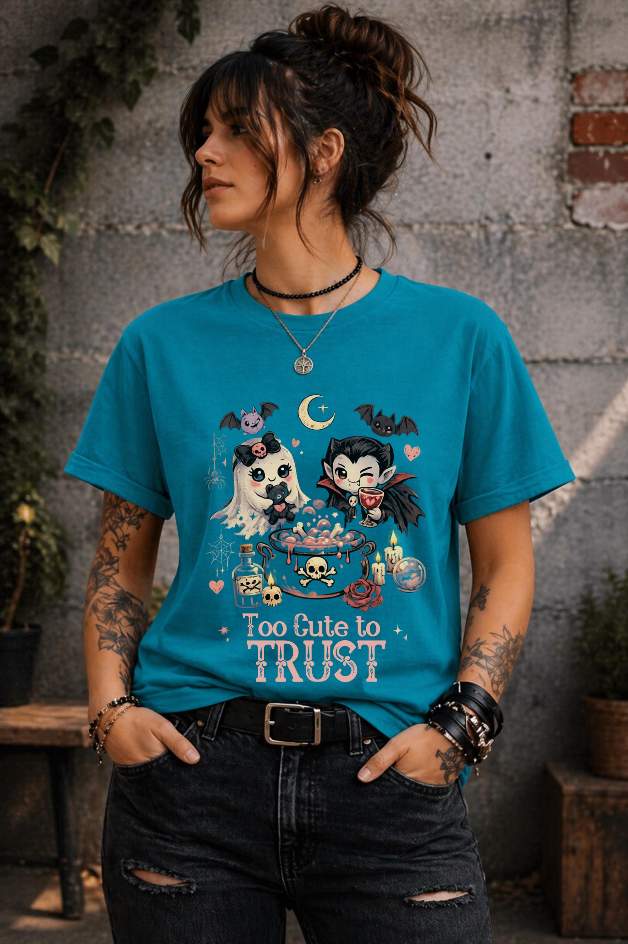 Whimsical spooky apparel featuring kawaii ghost and vampire characters with dark fantasy illustrations and pastel gothic colors.