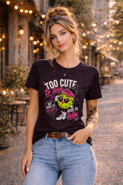 Woman wearing a Too Cute To Lose pickleball graphic t-shirt featuring a stylish pickleball character with heart sunglasses, pink visor, paddle artwork, and playful court-inspired design.