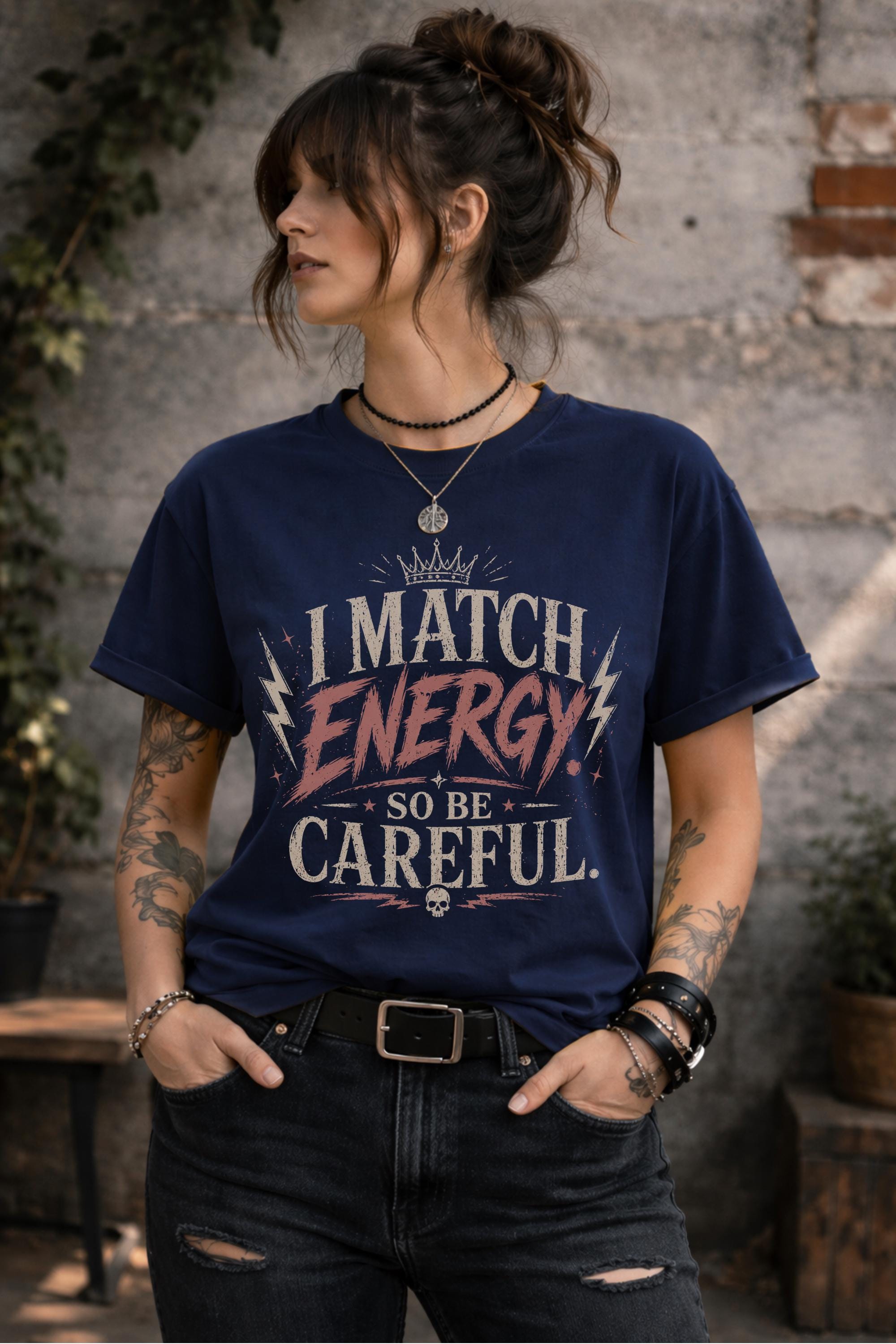 Woman wearing dark vintage wash graphic t-shirt featuring the phrase I Match Energy So Be Careful in distressed typography