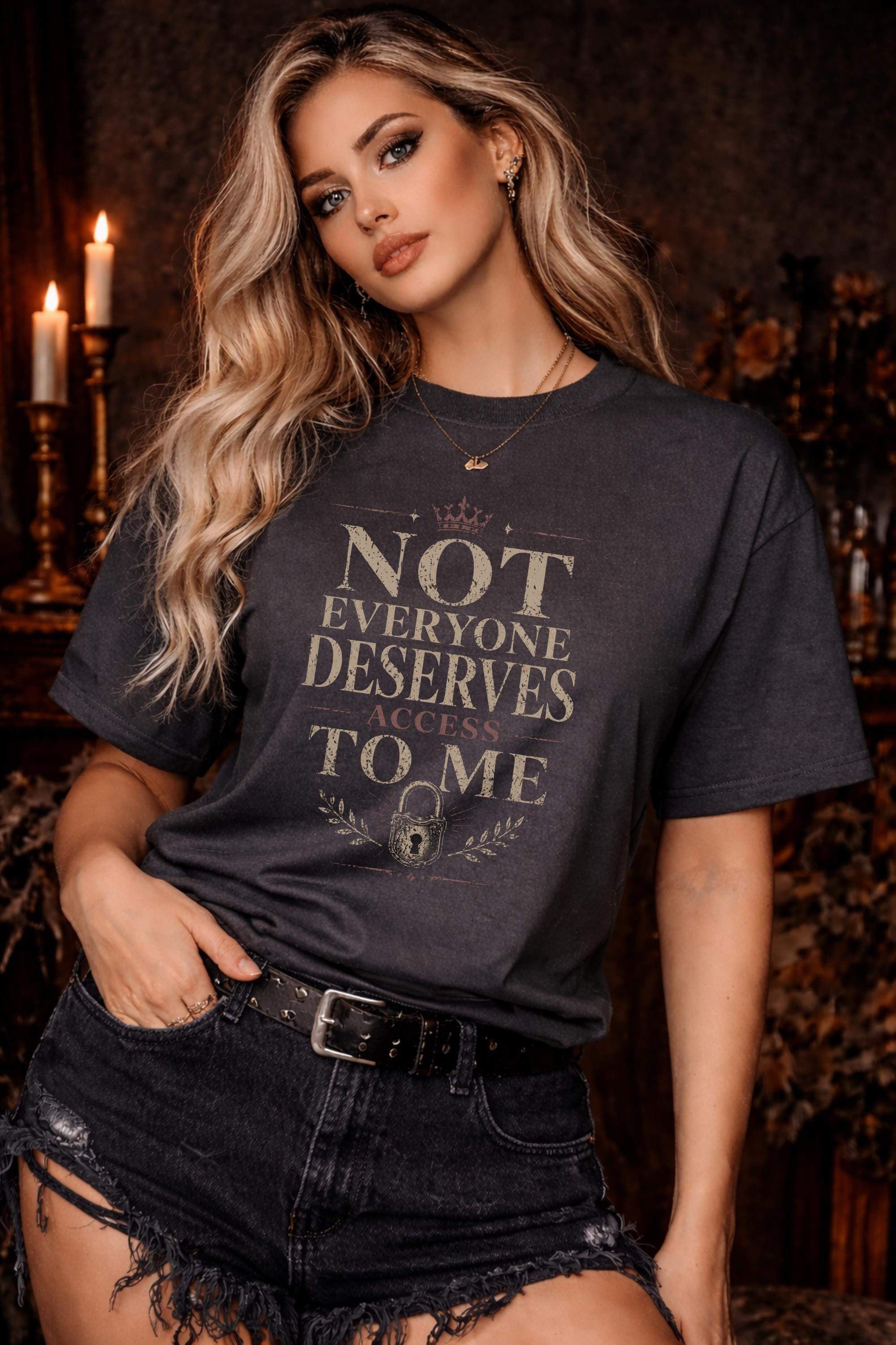 Woman wearing black graphic t-shirt with the phrase Not Everyone Deserves Access To Me in distressed vintage typography