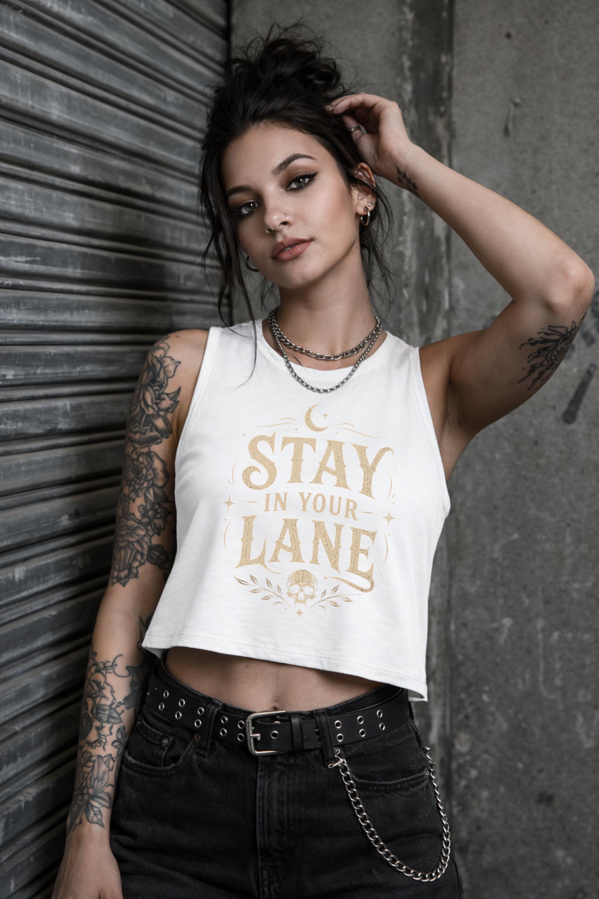 Woman wearing cropped Stay In Your Lane graphic tank with bold gothic lettering and alternative fashion styling