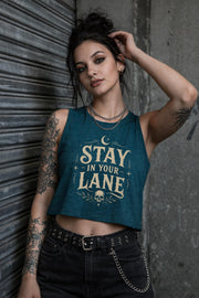 Woman wearing cropped Stay In Your Lane graphic tank with bold gothic lettering and alternative fashion styling