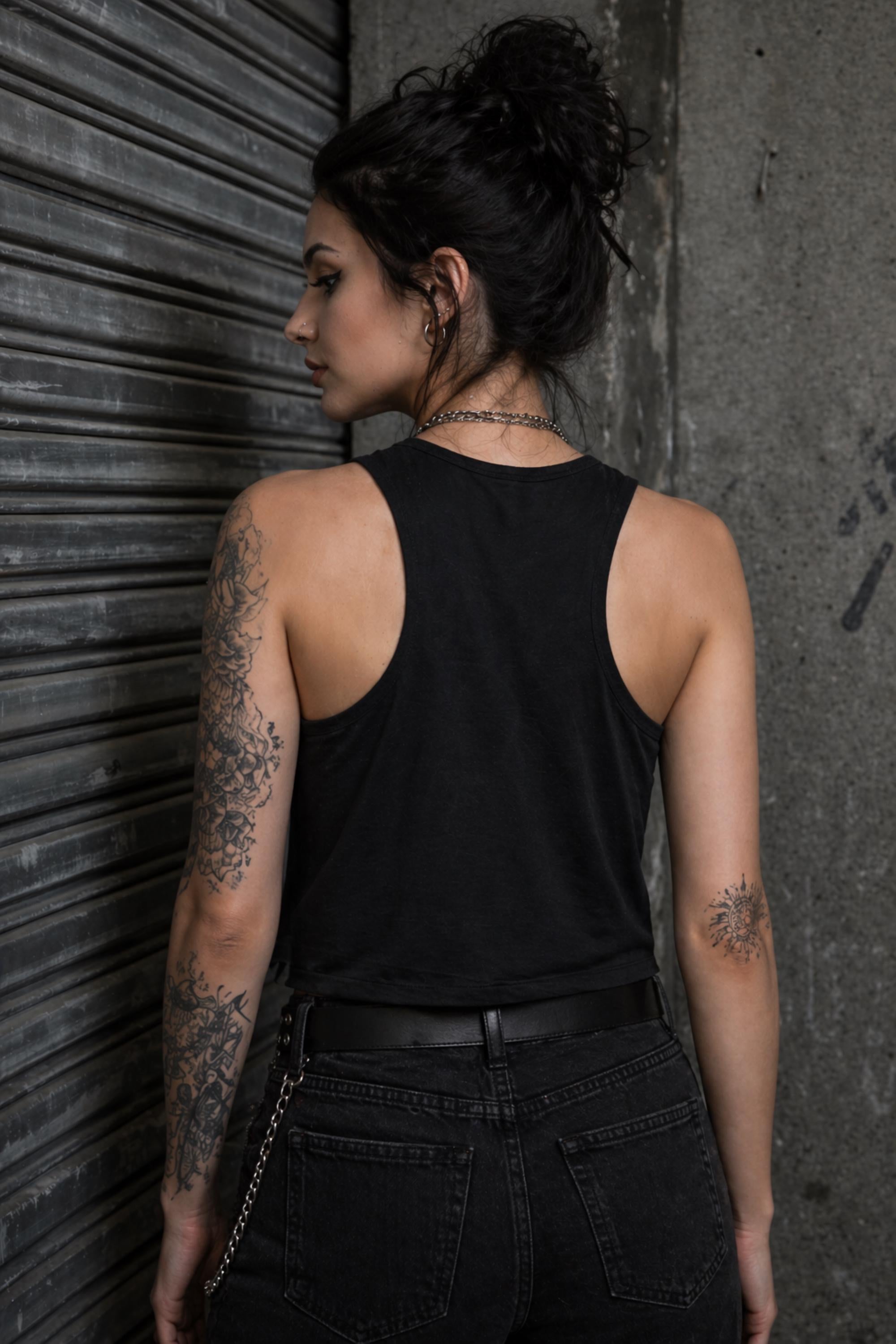 Woman wearing black cropped Stay In Your Lane graphic tank with bold gothic lettering and alternative fashion styling