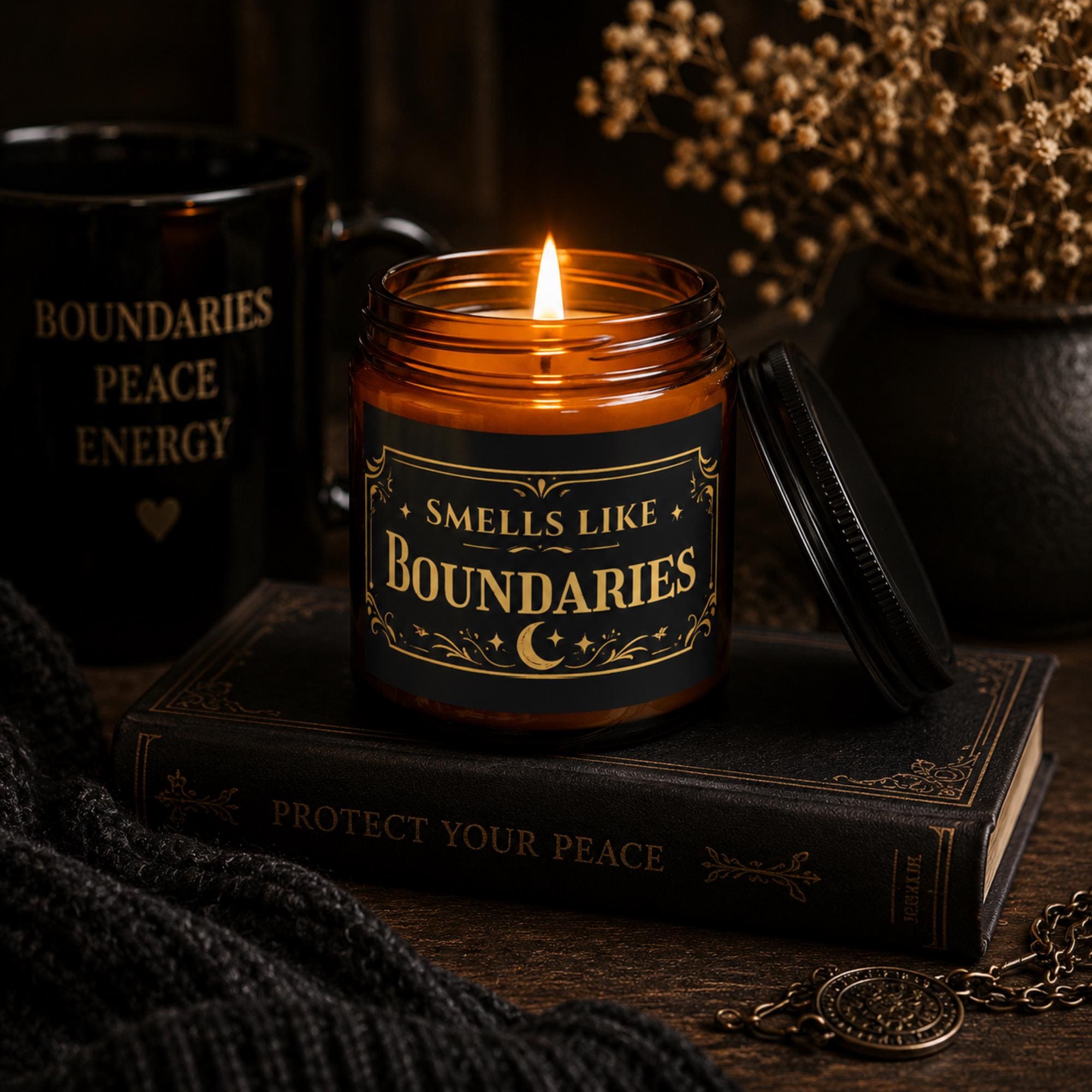 Lit amber soy candle with Smells Like Boundaries label, gothic self care candle for cozy home decor