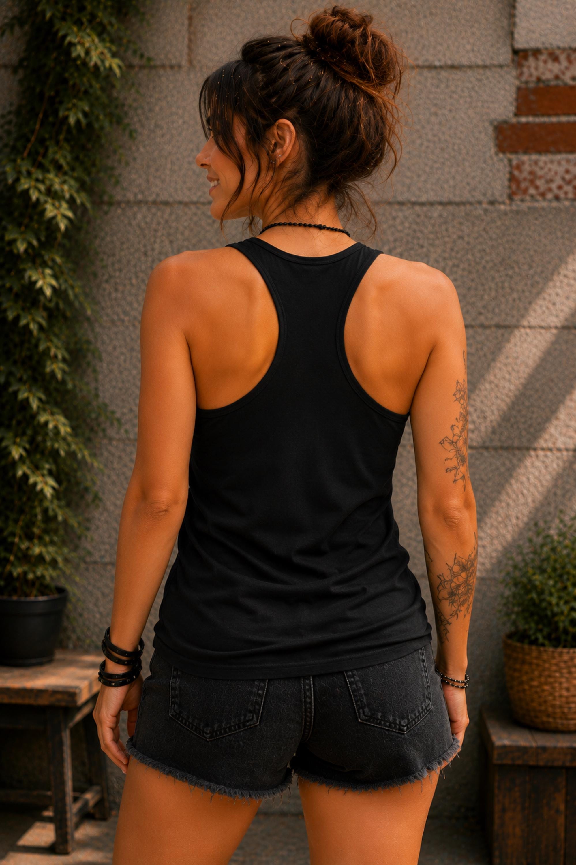 Black racerback tank featuring the back of the colorful rainbow unicorn and Stay Magical quote