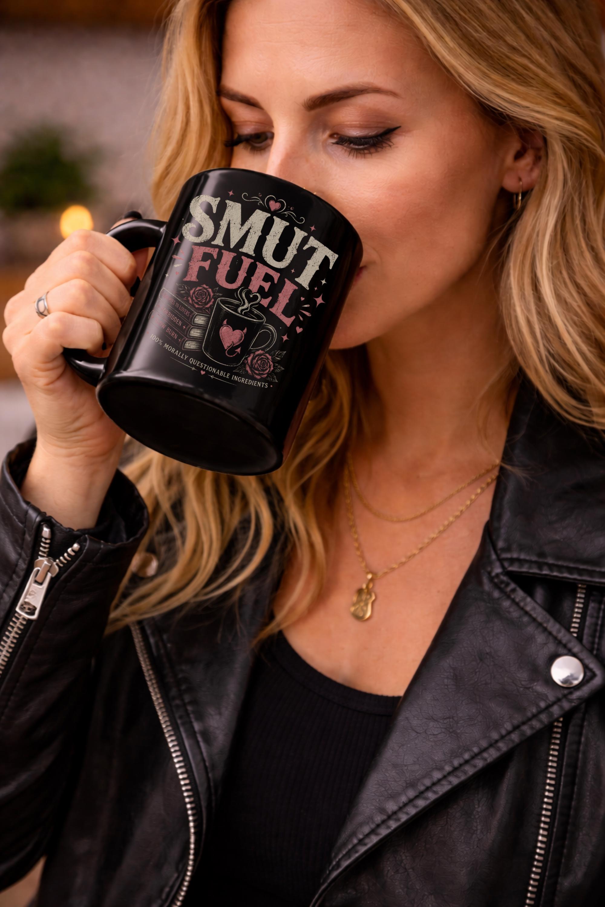 Woman sipping black ceramic mug with Fueled by Smut & Caffeine design for dark romance book lovers