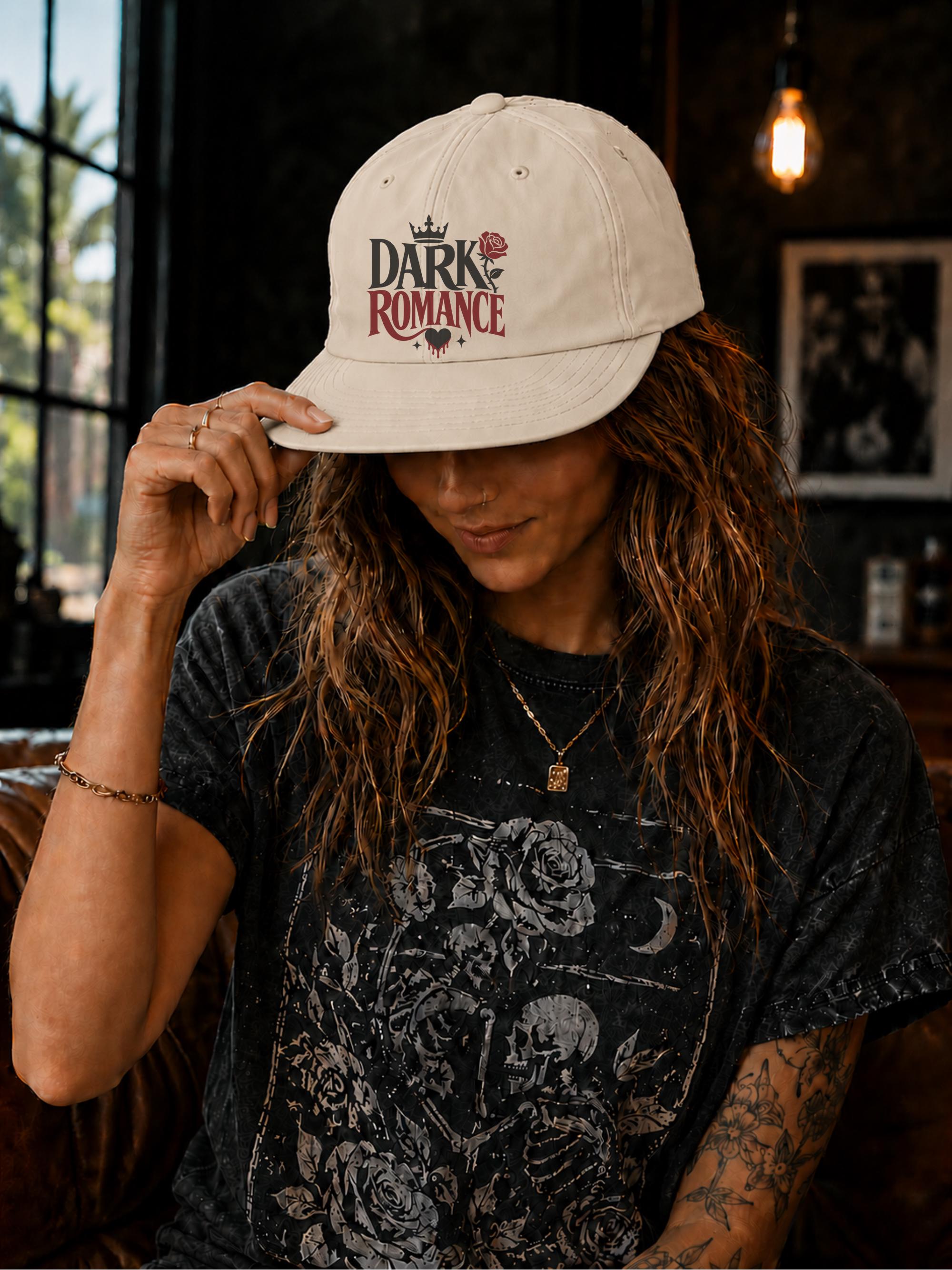 Woman wearing a surf cap featuring a Dark Romance graphic with red rose detail, photographed in a moody bookish setting with dark academia aesthetic.