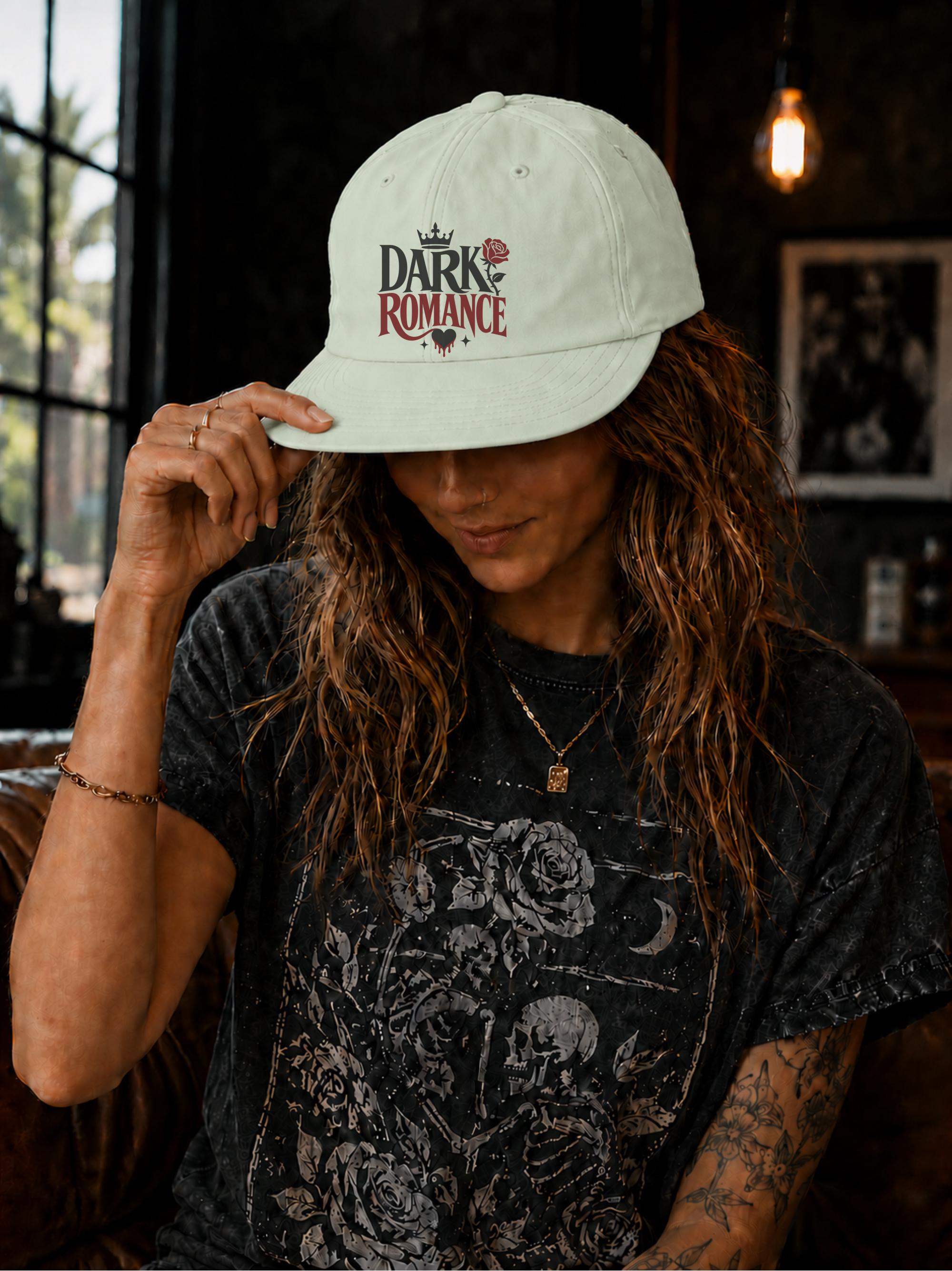 Woman wearing a surf cap featuring a Dark Romance graphic with red rose detail, photographed in a moody bookish setting with dark academia aesthetic.