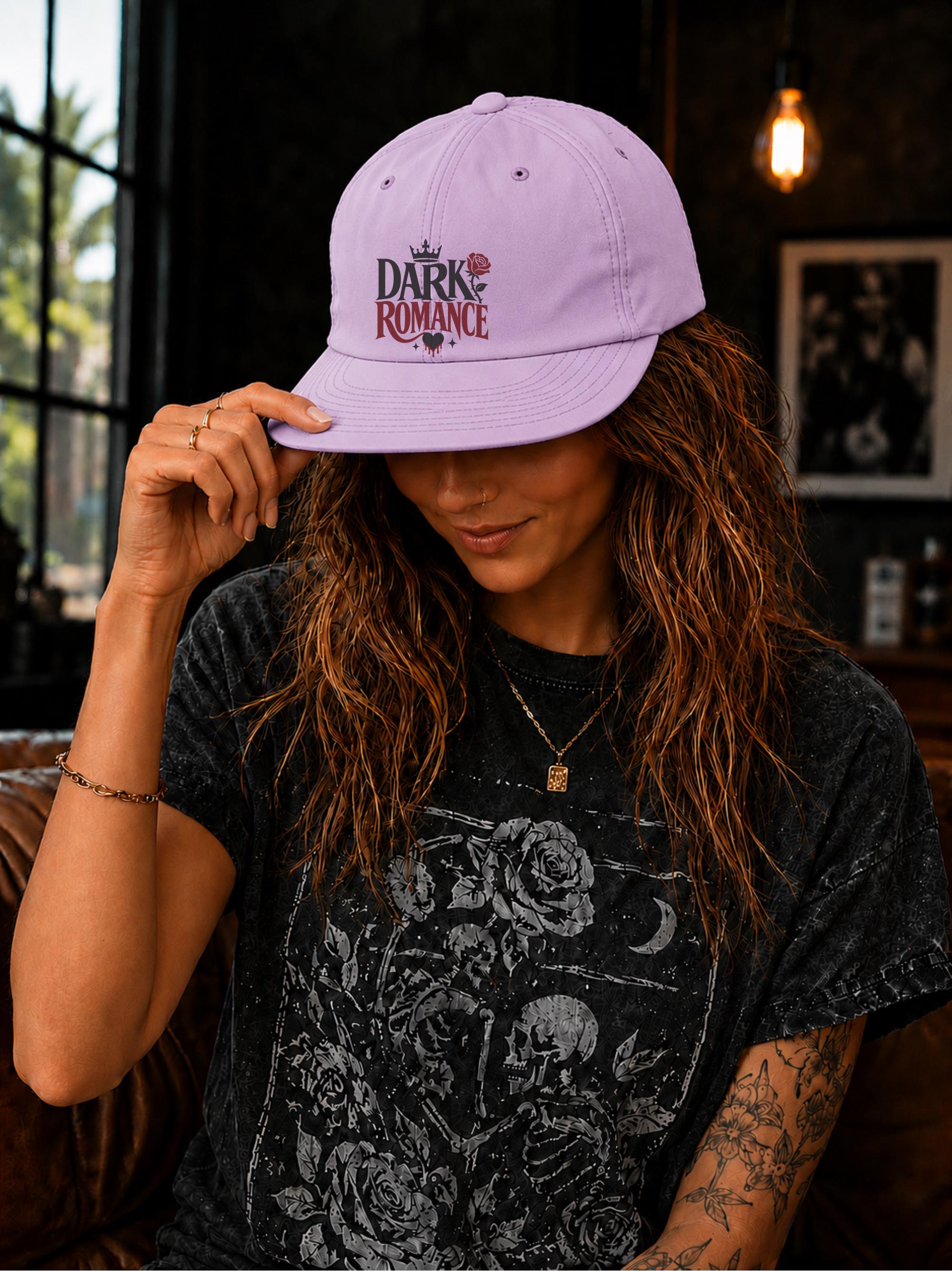 Woman wearing a surf cap featuring a Dark Romance graphic with red rose detail, photographed in a moody bookish setting with dark academia aesthetic.