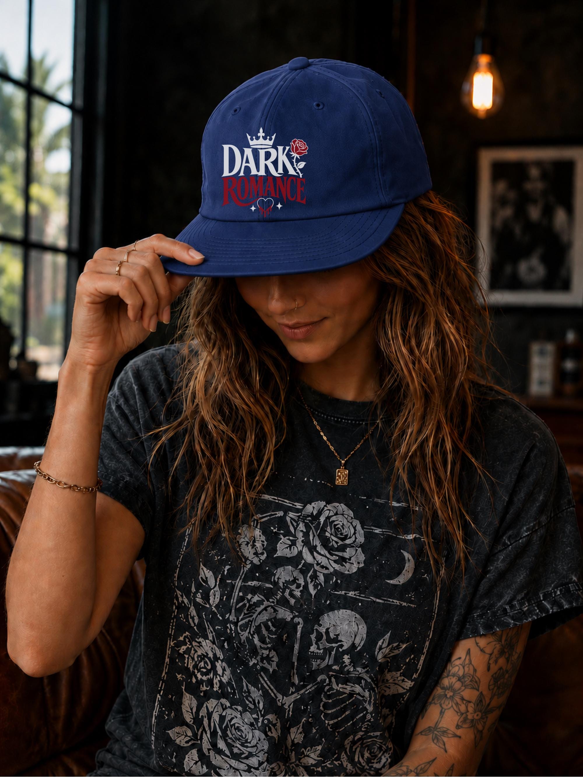 Woman wearing a surf cap featuring a Dark Romance graphic with red rose detail, photographed in a moody bookish setting with dark academia aesthetic.