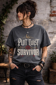 Woman wearing a  graphic t-shirt featuring the phrase "Plot Twist Survivor" with gothic lettering, red rose artwork, and dark romance bookish aesthetic.