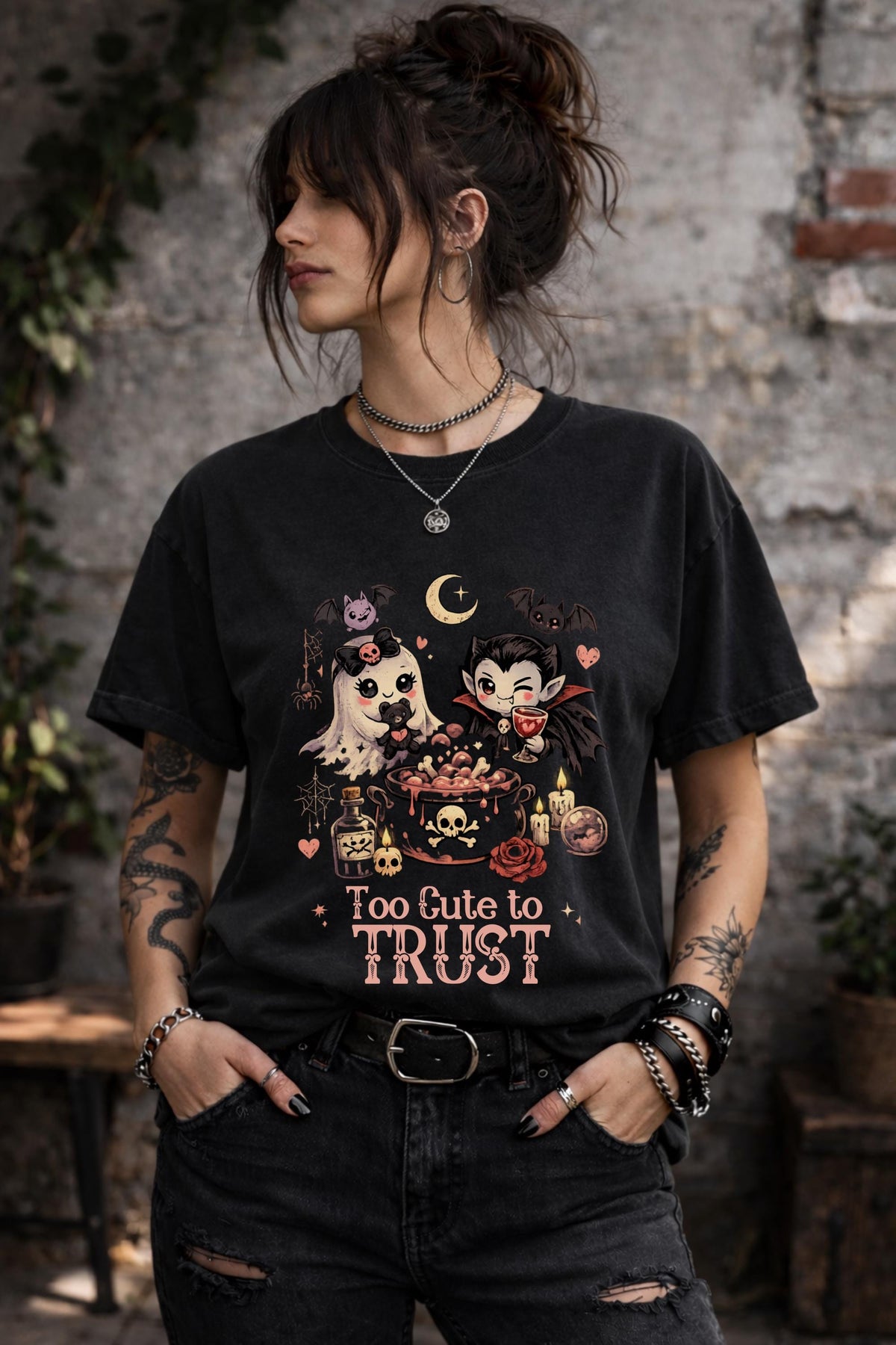 Alternative Halloween graphic shirt showcasing cute supernatural characters, magical potions, bats, hearts, and gothic aesthetic artwork.