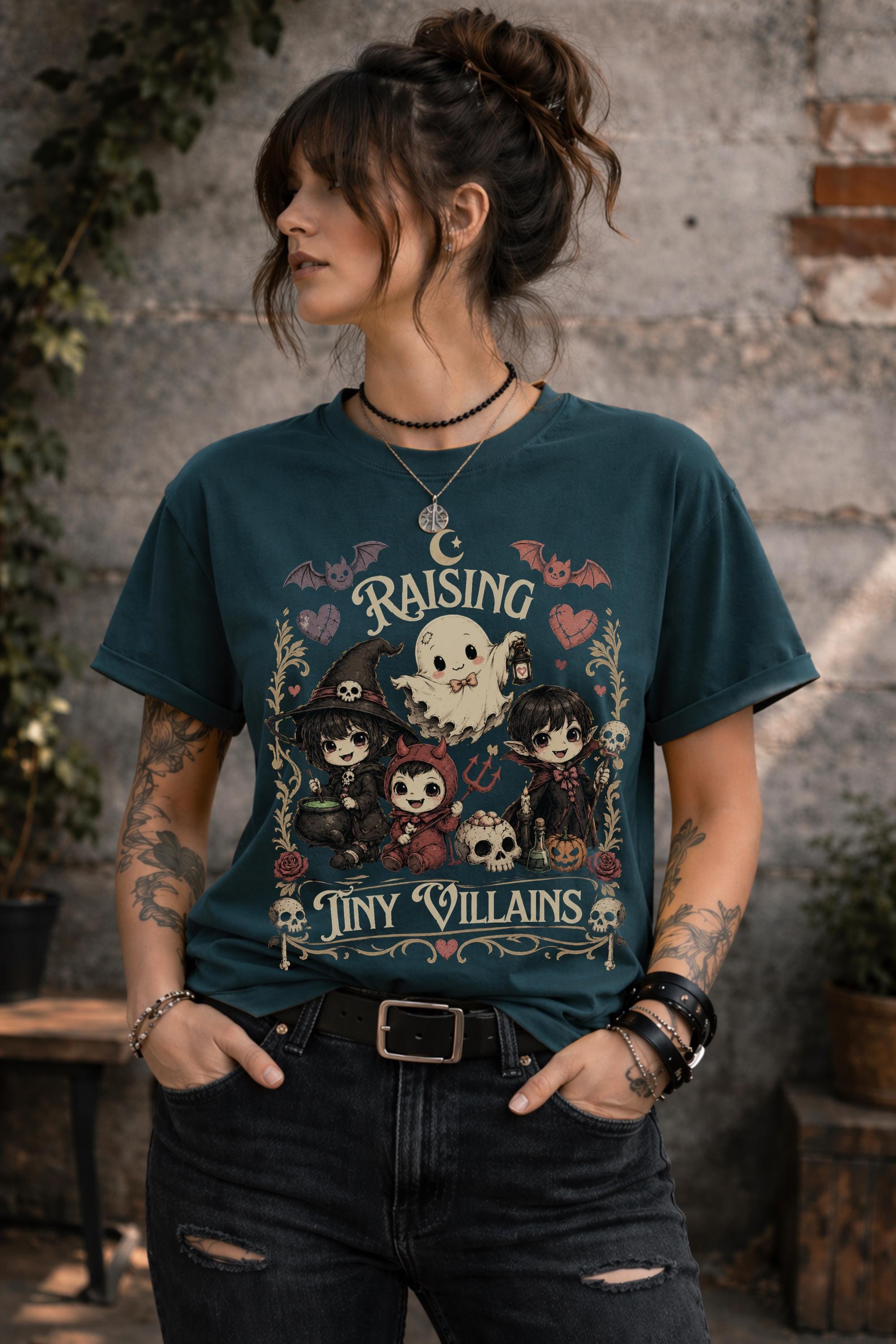 Gothic Halloween shirt with adorable cartoon ghost and tiny villains surrounded by skulls, roses, bats, and whimsical spooky details.