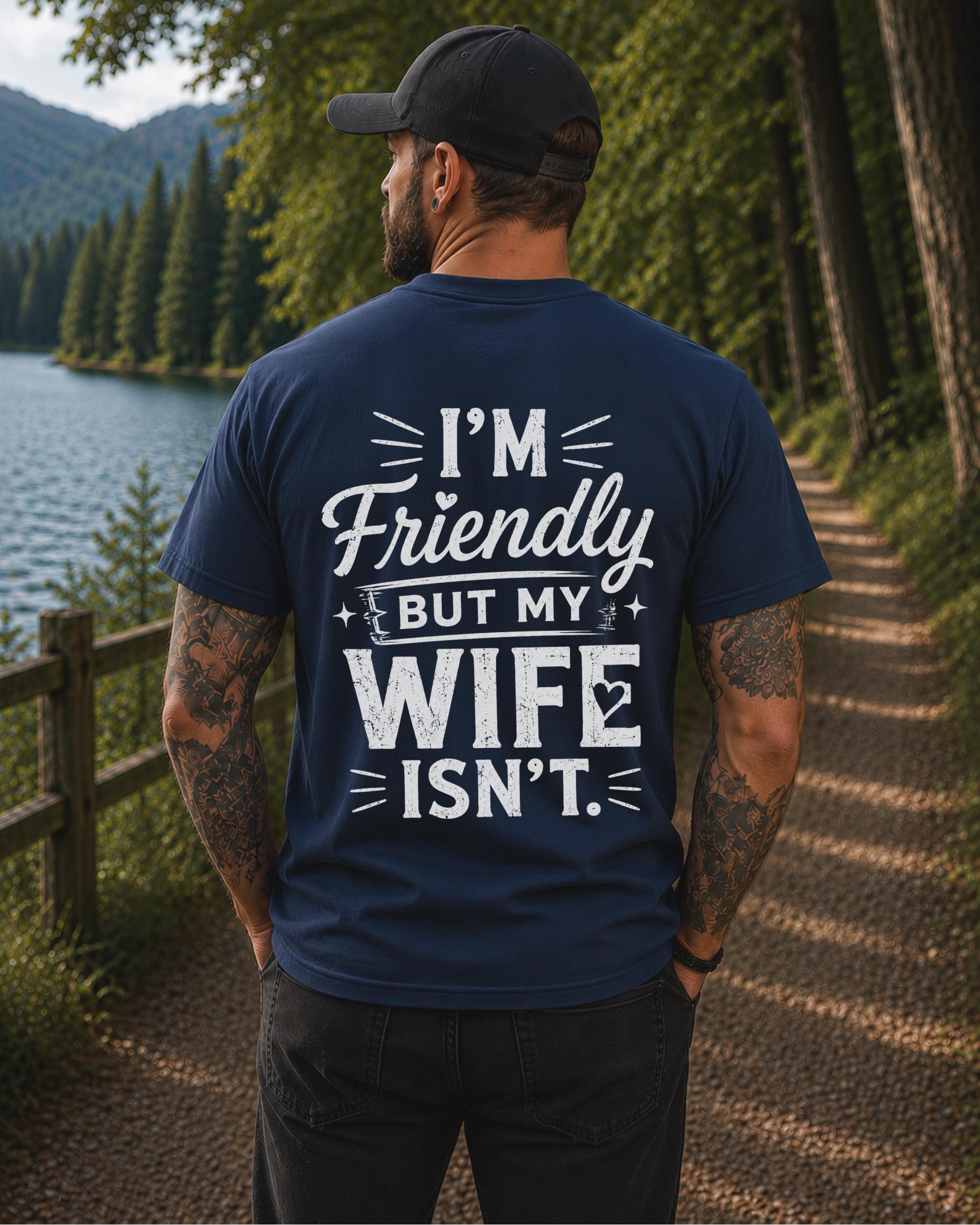 Back view of a black shirt featuring the humorous phrase "I'm Friendly But My Wife Isn't" in distressed white typography.