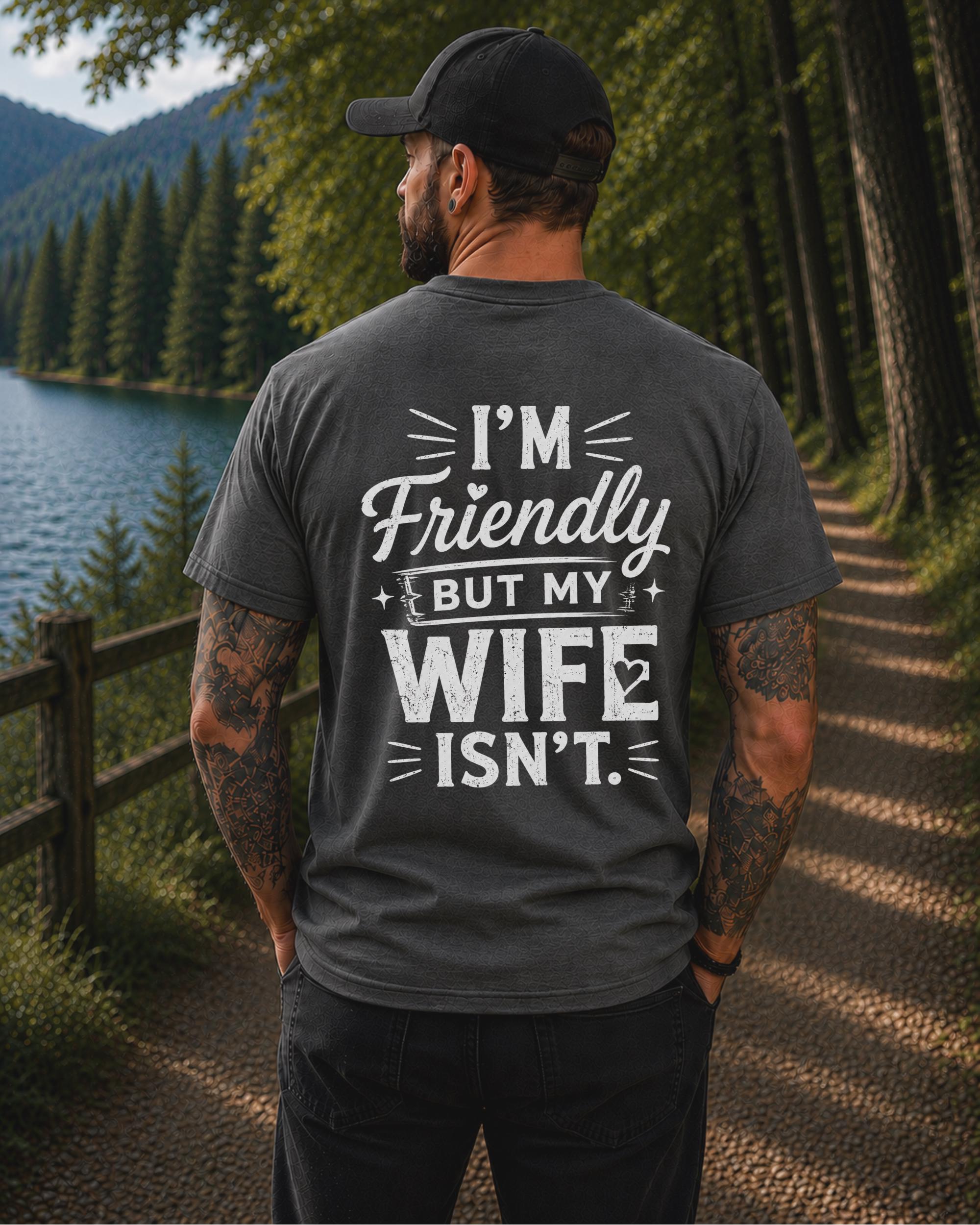 Back view of a black shirt featuring the humorous phrase "I'm Friendly But My Wife Isn't" in distressed white typography.