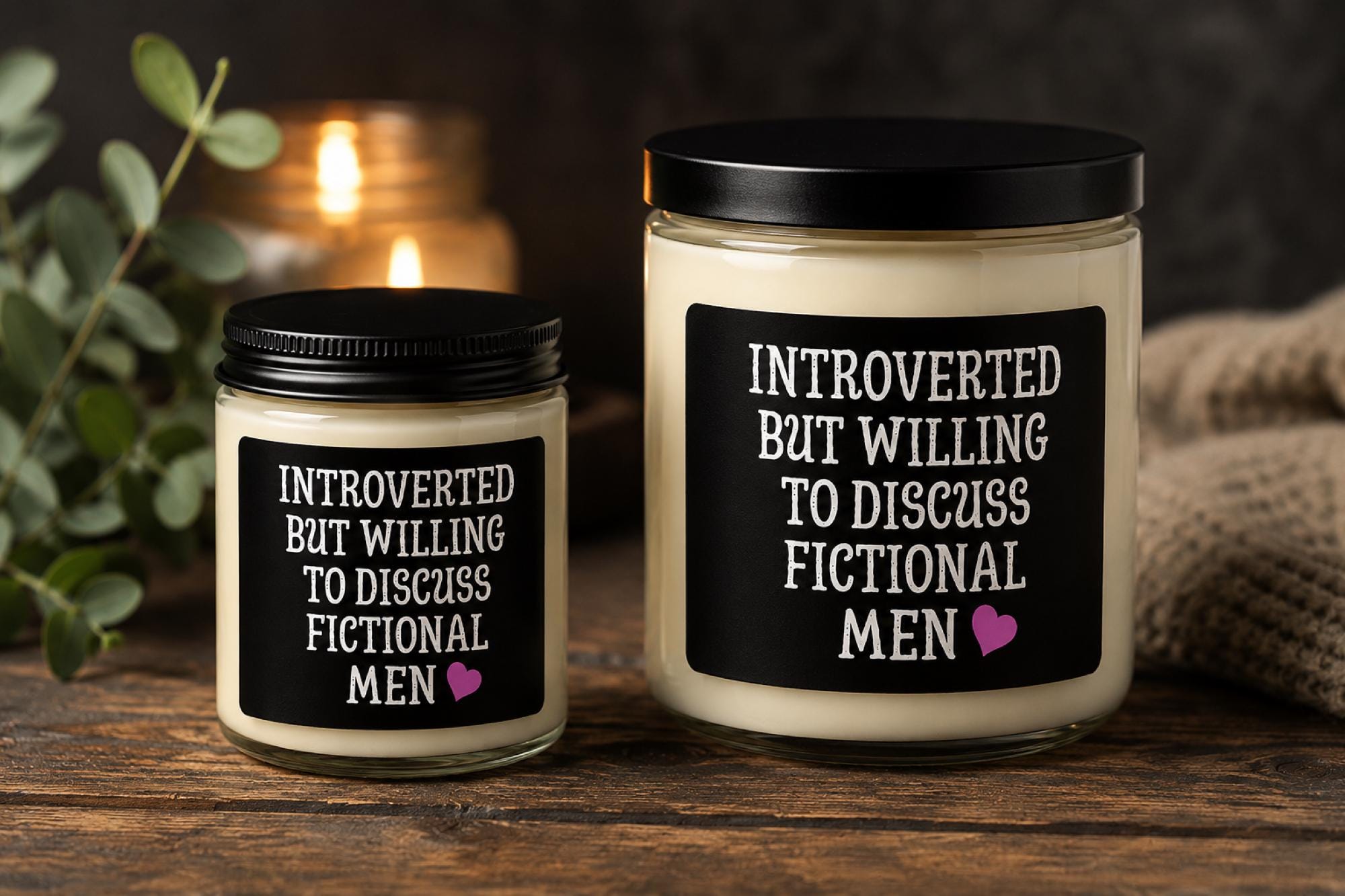 Dark romance themed scented soy candles featuring the phrase "Introverted But Willing To Discuss Fictional Men" displayed alongside gothic books and candlelit decor.