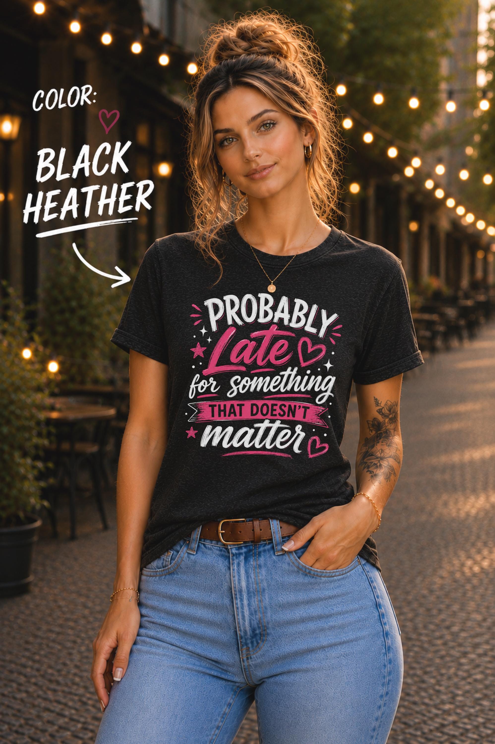 Woman wearing black heather graphic t-shirt featuring the phrase "Probably Late for Something That Doesn't Matter" in pink and white typography with playful heart accents.