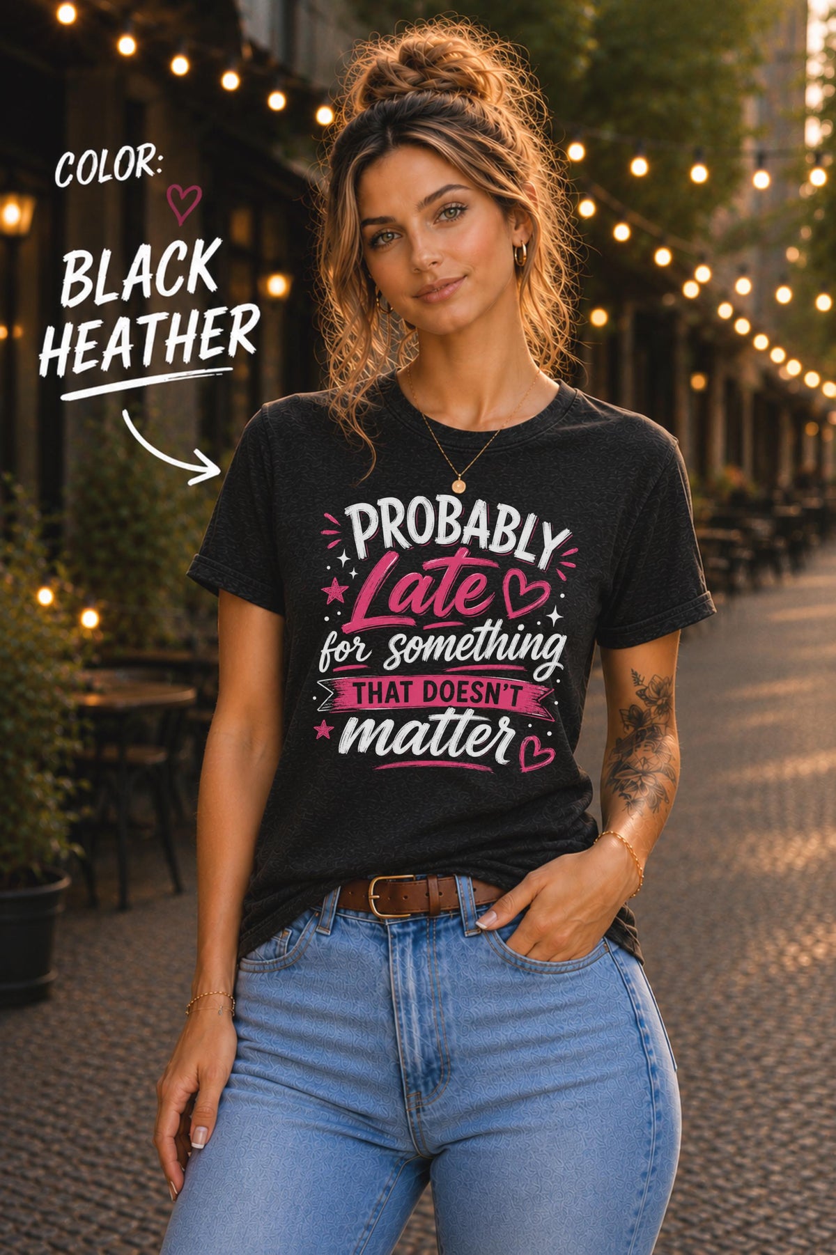 Woman wearing black heather graphic t-shirt featuring the phrase "Probably Late for Something That Doesn't Matter" in pink and white typography with playful heart accents.