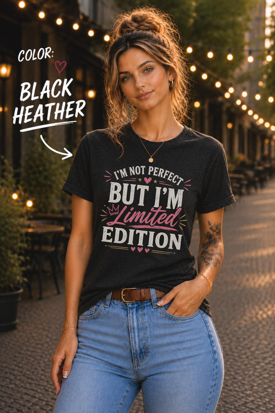 Woman modeling a Black Heather Bella+Canvas 3001 unisex t-shirt featuring the "I'm Not Perfect But I'm Limited Edition" graphic in white and pink lettering.