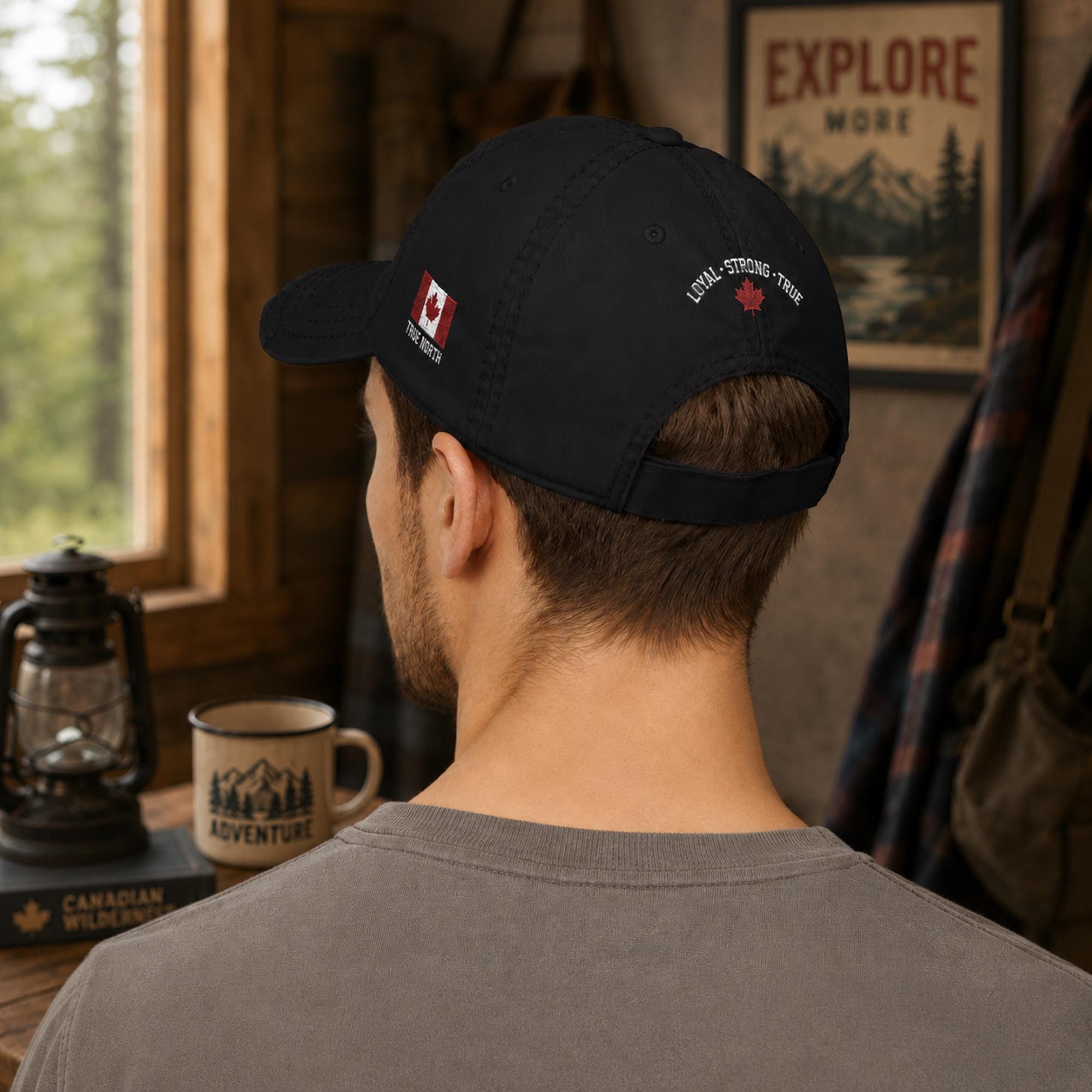 Black distressed embroidered dad hat featuring a bold "Proud Army Dad" design on the front with a red maple leaf and "EH!" & "True North" & on the back "Loyal - Strong - True" embroidery on the side, styled in a rustic outdoor setting with camping accessories.