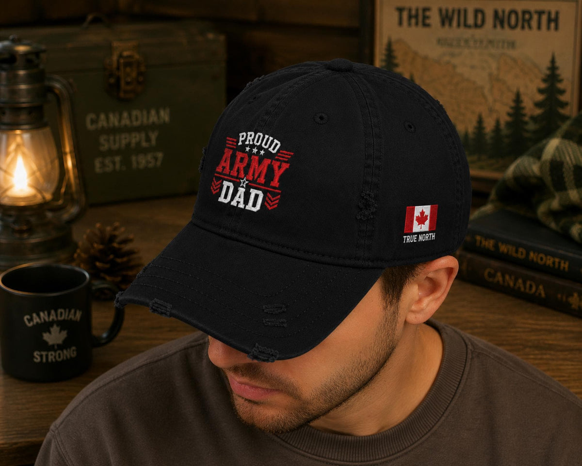 Black distressed embroidered dad hat featuring a bold "Proud Army Dad" design on the front with a red maple leaf and "EH!" embroidery on the side, styled in a rustic outdoor setting with camping accessories.