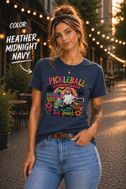 Halloween pickleball t-shirt featuring a ghost playing pickleball at the beach with tropical summer artwork.