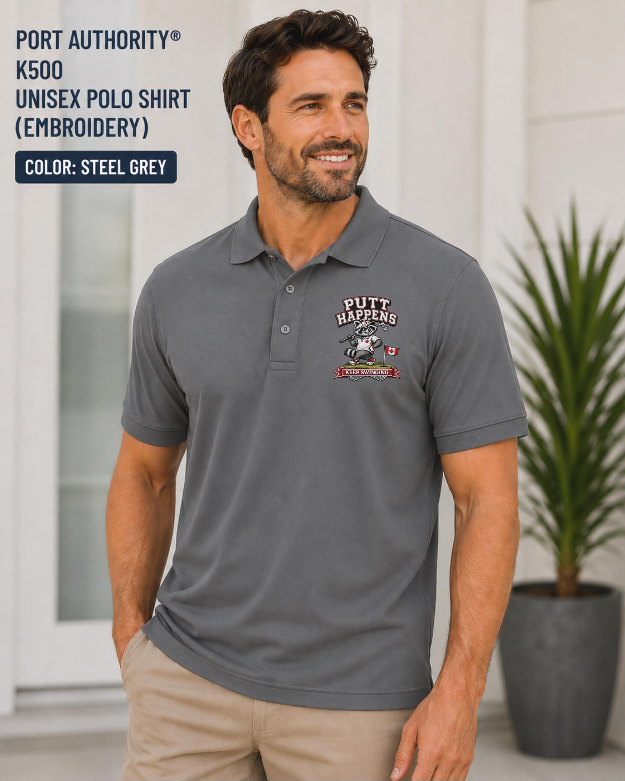 Steel Grey Port Authority K500 embroidered golf polo featuring a funny raccoon golfer design with the phrase Putt Happens and Keep Swinging