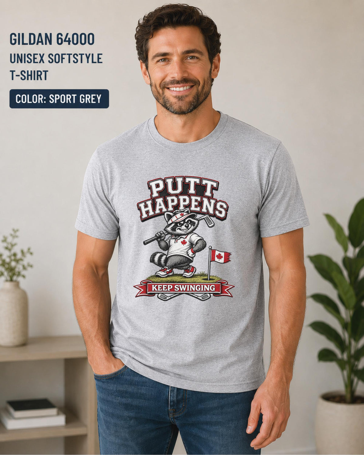 Sport grey Gildan 64000 golf t-shirt featuring a funny raccoon golfer with Putt Happens Keep Swinging design and Canadian flag accent