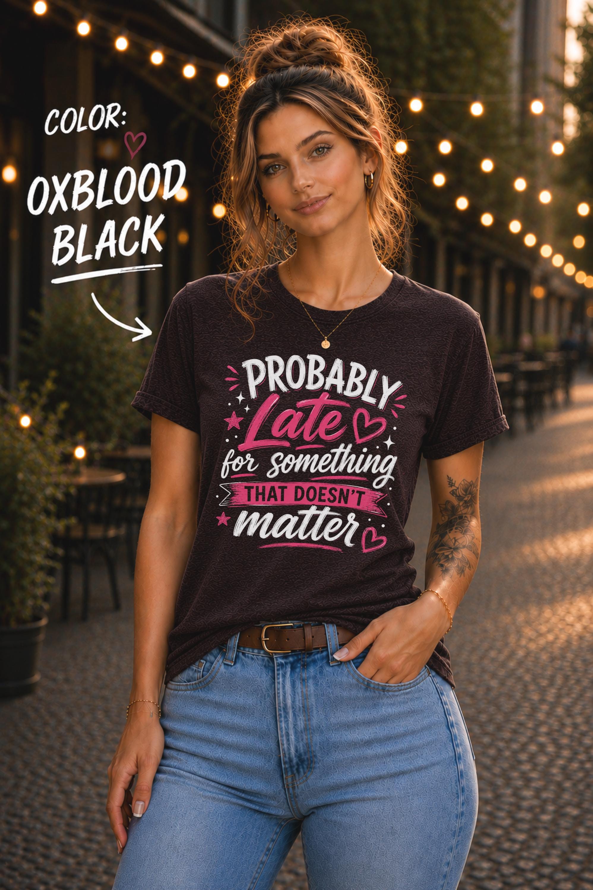 Woman wearing Oxblood black graphic t-shirt featuring the phrase "Probably Late for Something That Doesn't Matter" in pink and white typography with playful heart accents.