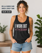 Woman wearing a black Bella+Canvas jersey tank featuring the phrase "I Work Out So I Can Eat Snacks" in white and pink lettering.